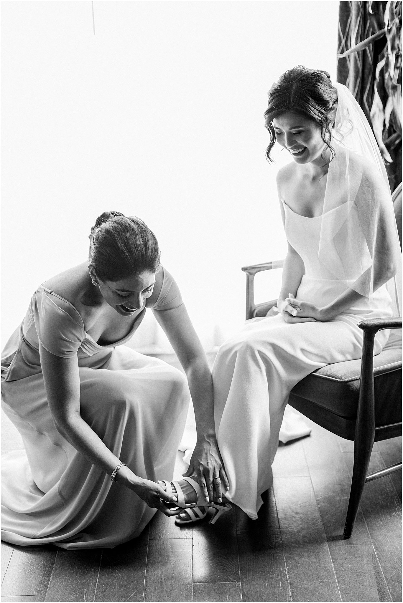 Maid of Honor helping the bride with her shoes at Terranea Resort wedding by Teresa Marie Photography.