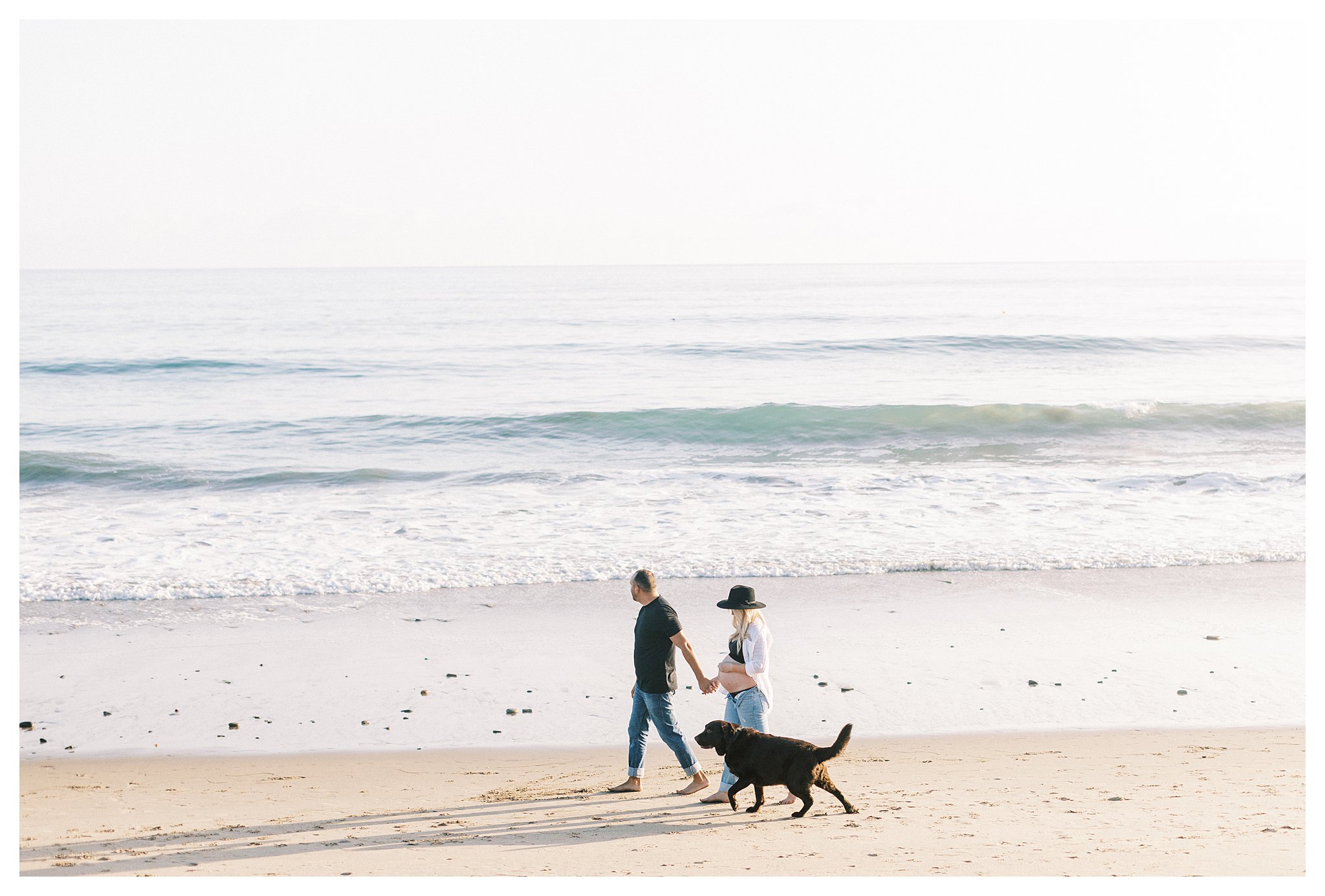 A couple walking with their dog during their photo session 