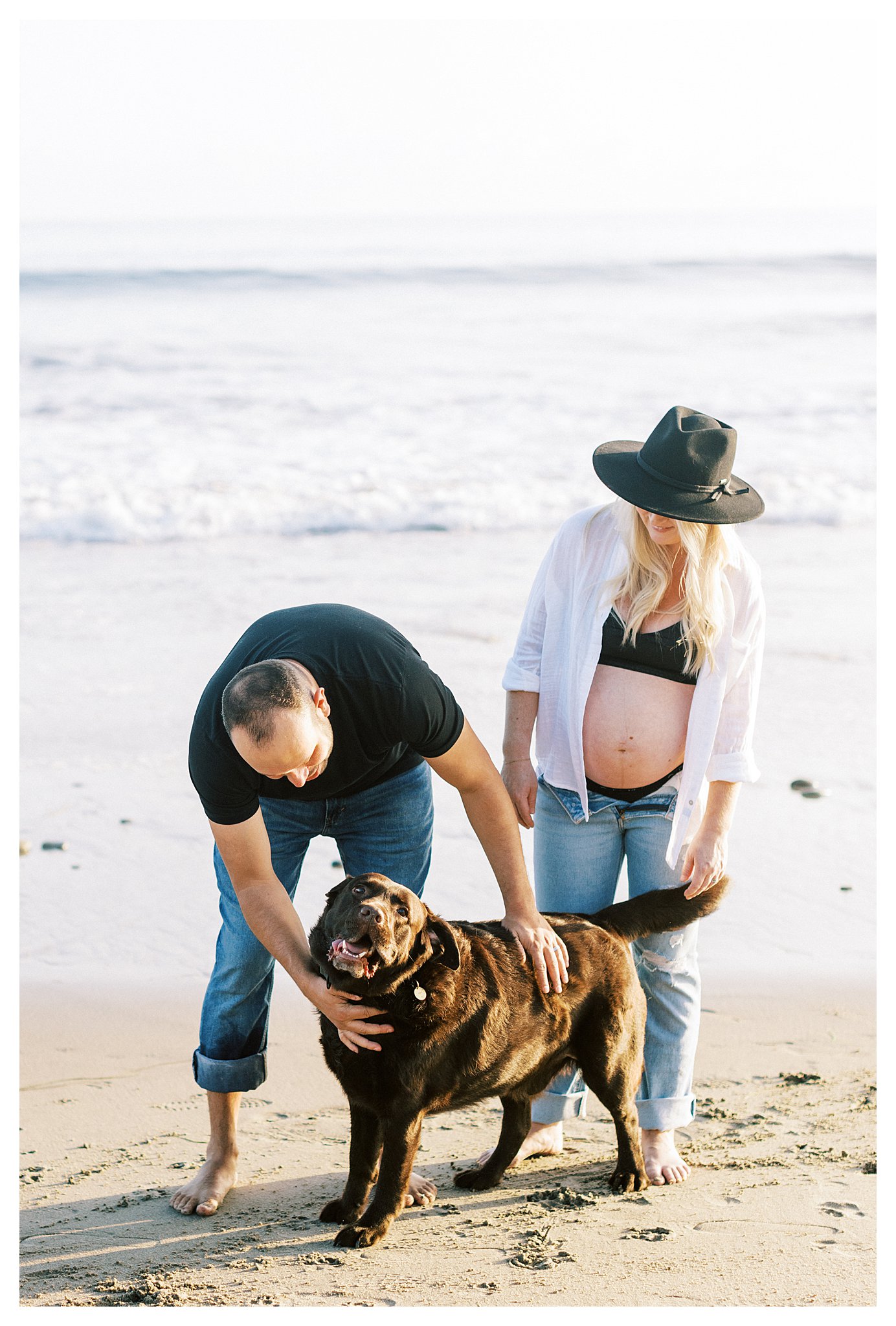 A couple during their maternity session with their dog in Malibu, Ca.