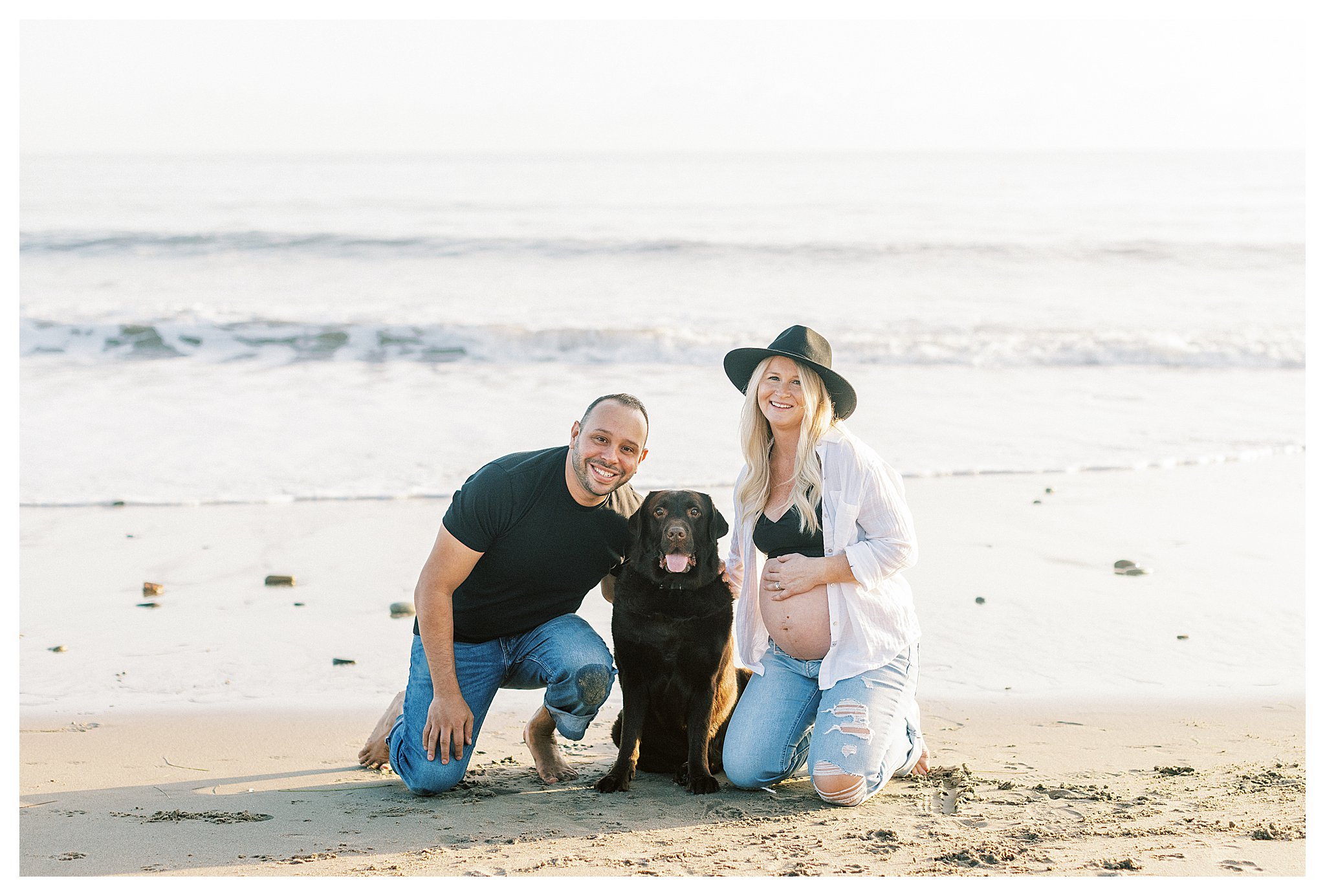 A couple with their dog during their maternity session at Leo Carrillo beach.