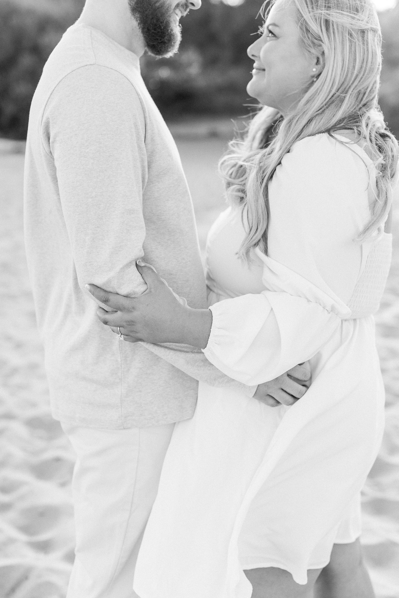 A couple looking at each other during their engagement session in Malibu, Ca.