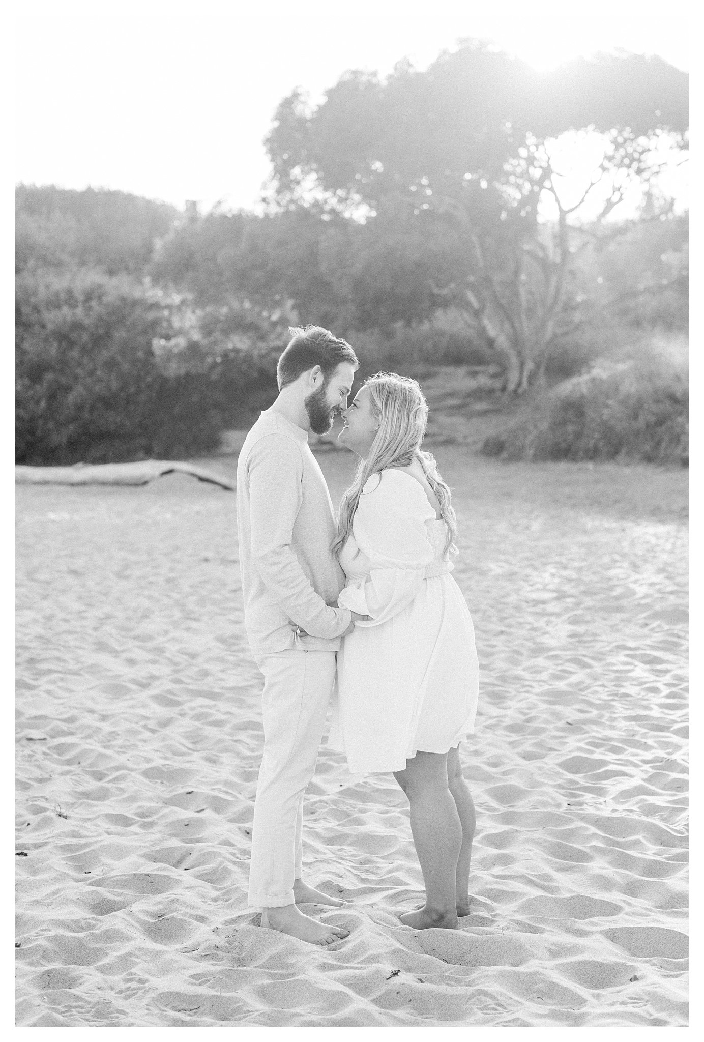 A couple smiling and gazing at each other during their photo session.  