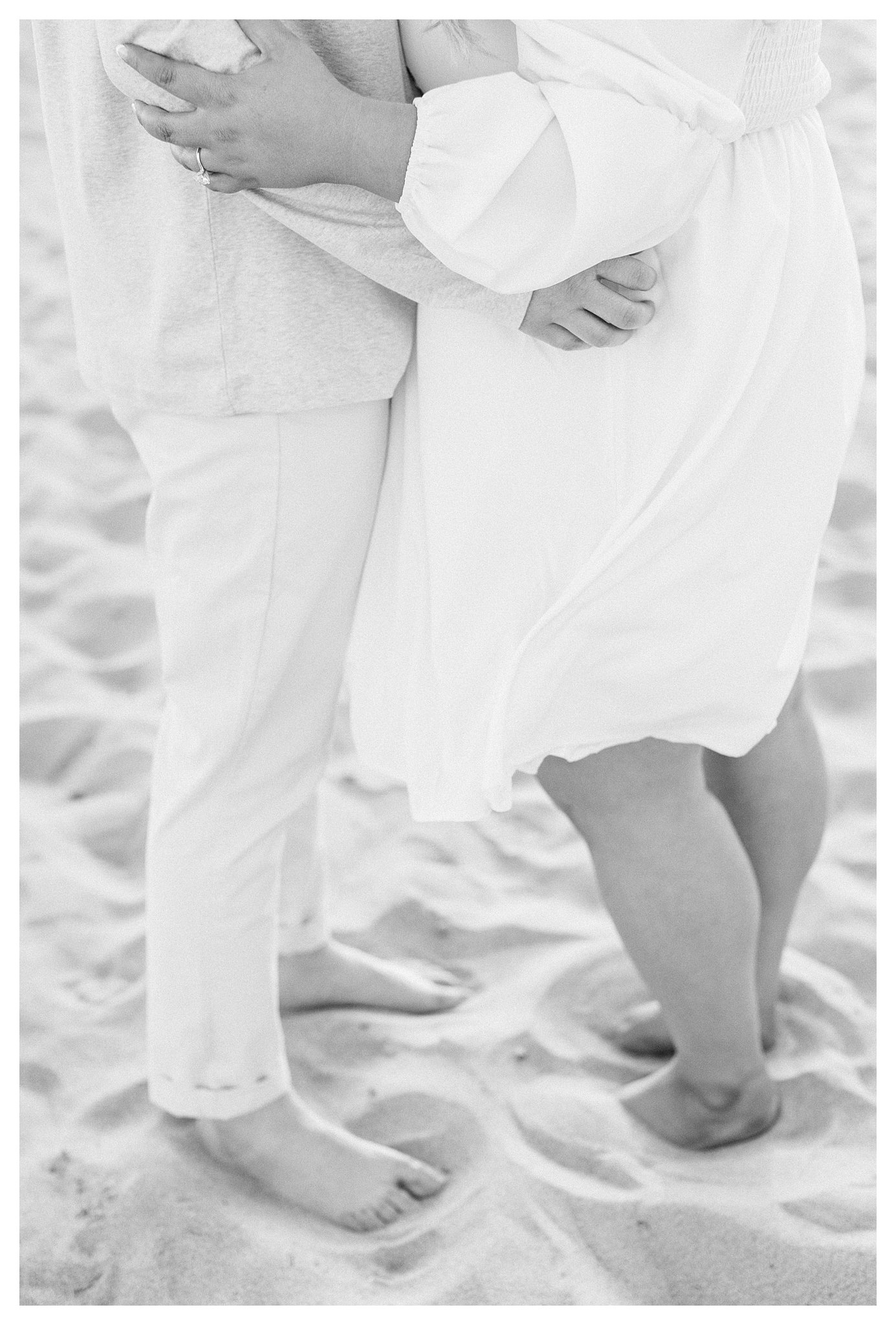 A couple hugs on the beach at Leo Carrillo in Malibu, Ca.