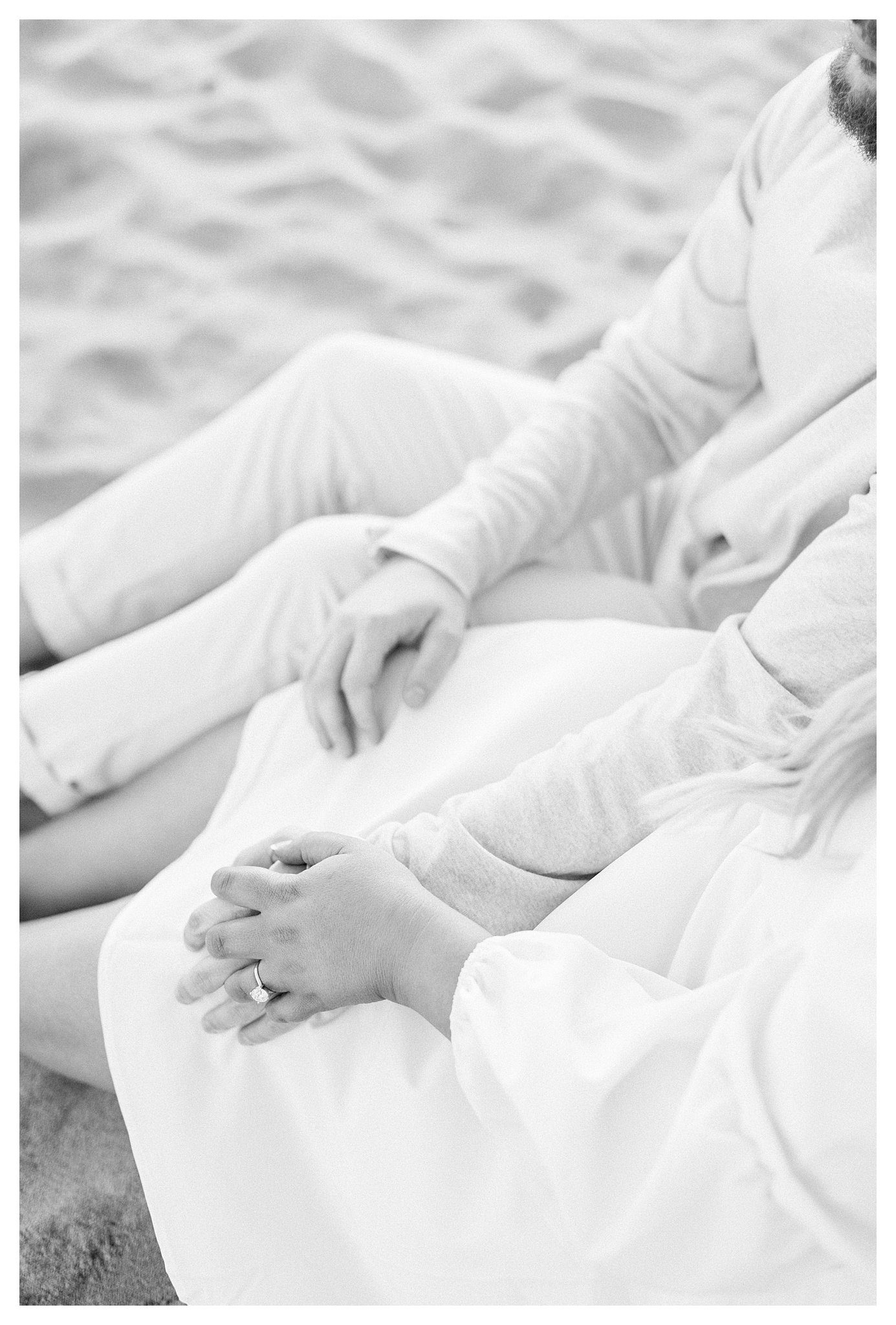 Close-up of couple's hands, highlighting the engagement ring.