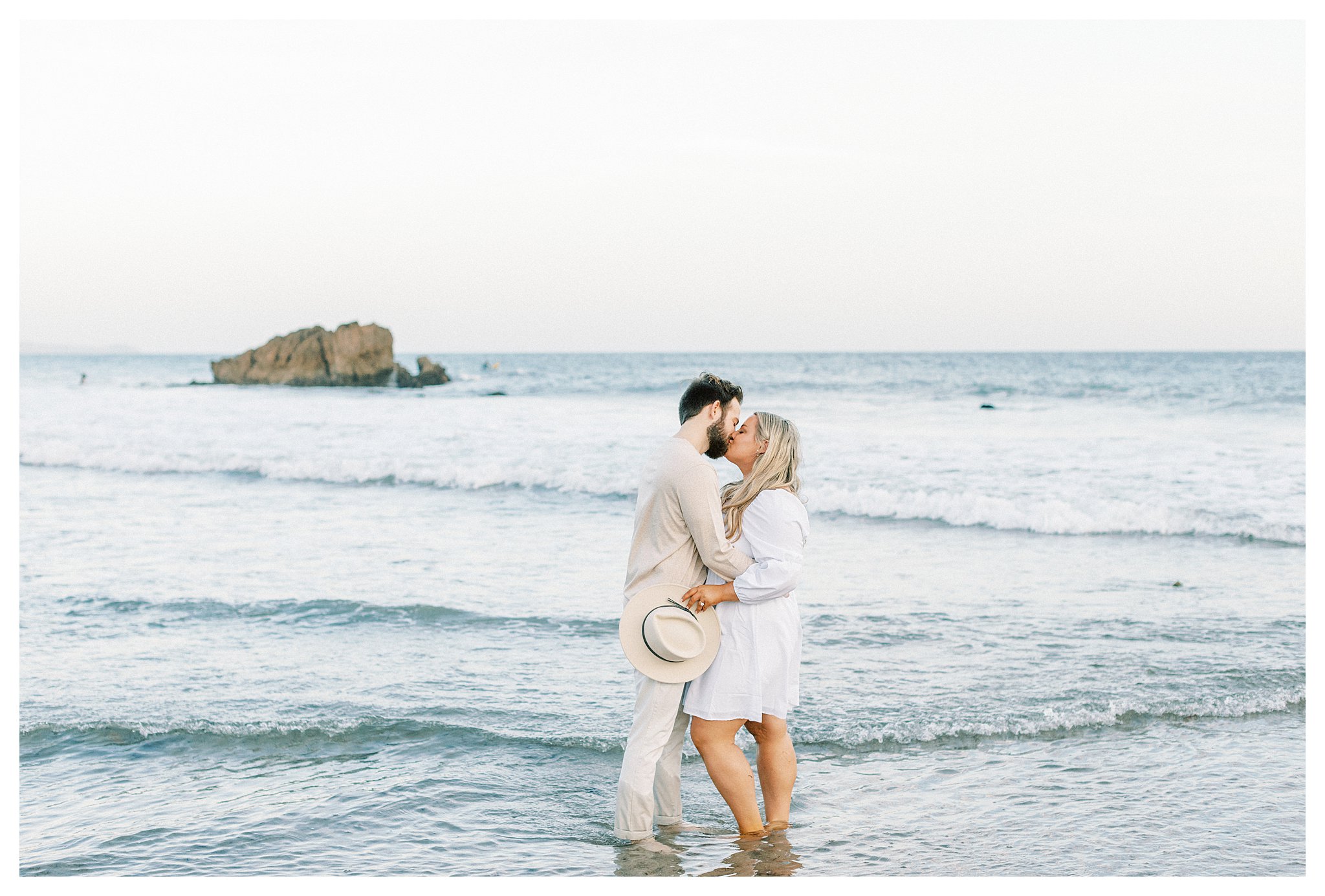 A couple kissing in the water at Leo Carrillo beach in Malibu, Ca.