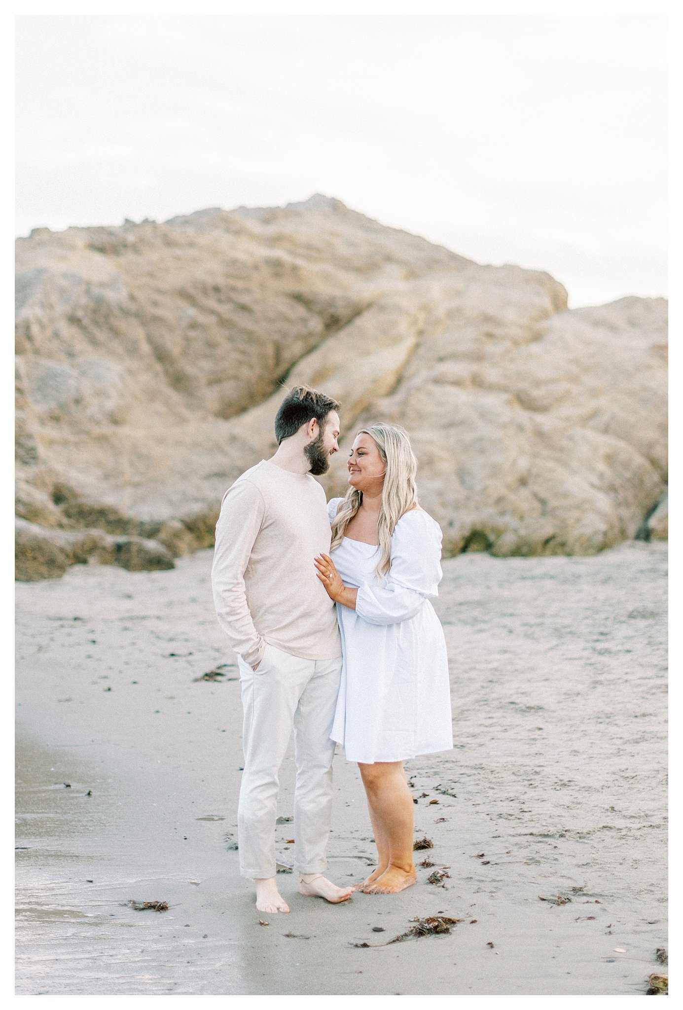 Tender moment: Couple looking at each other by the sea.