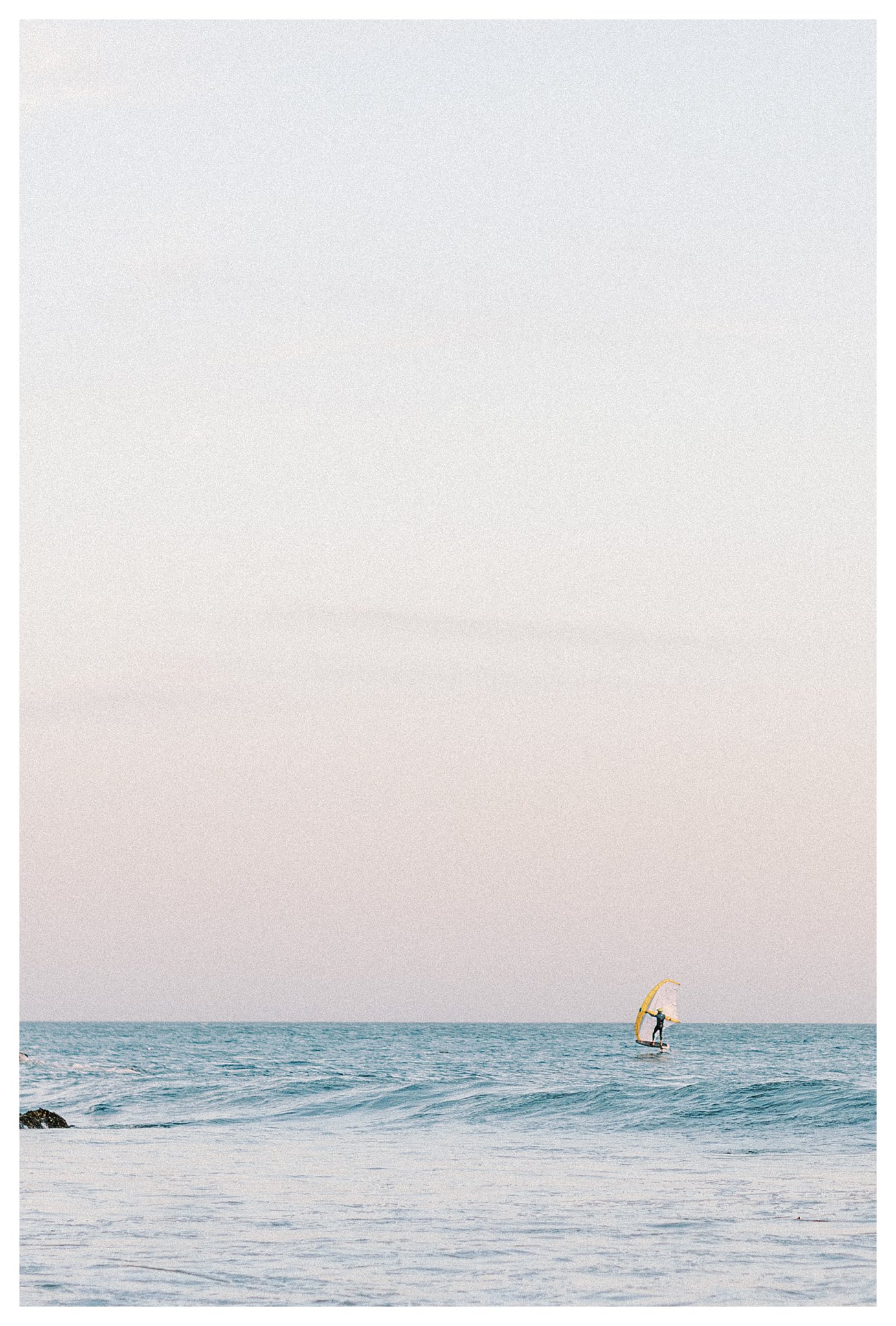 Kite surfer navigating the waves with skill.