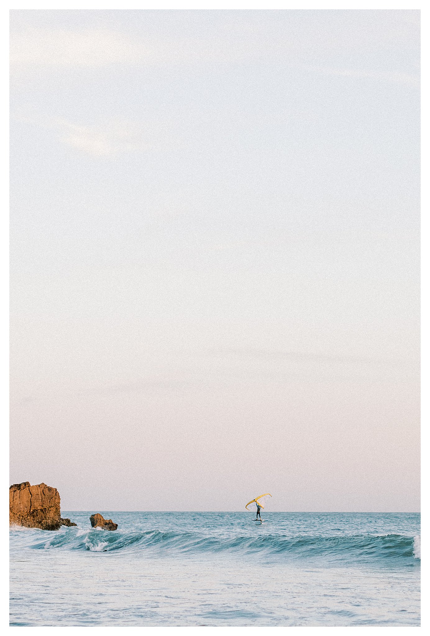 A kite surfer carving through the water with finesse at Leo Carrillo beach. 