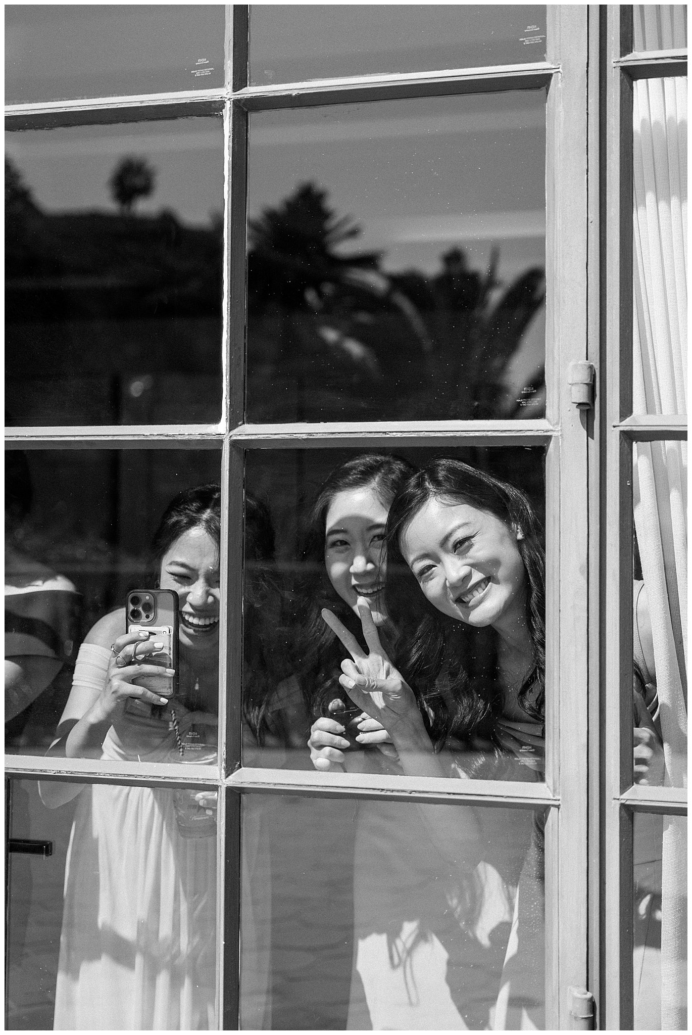 Bridesmaids looking out the window at Bel Air Bay Club in Pacific Palisades, Ca. 