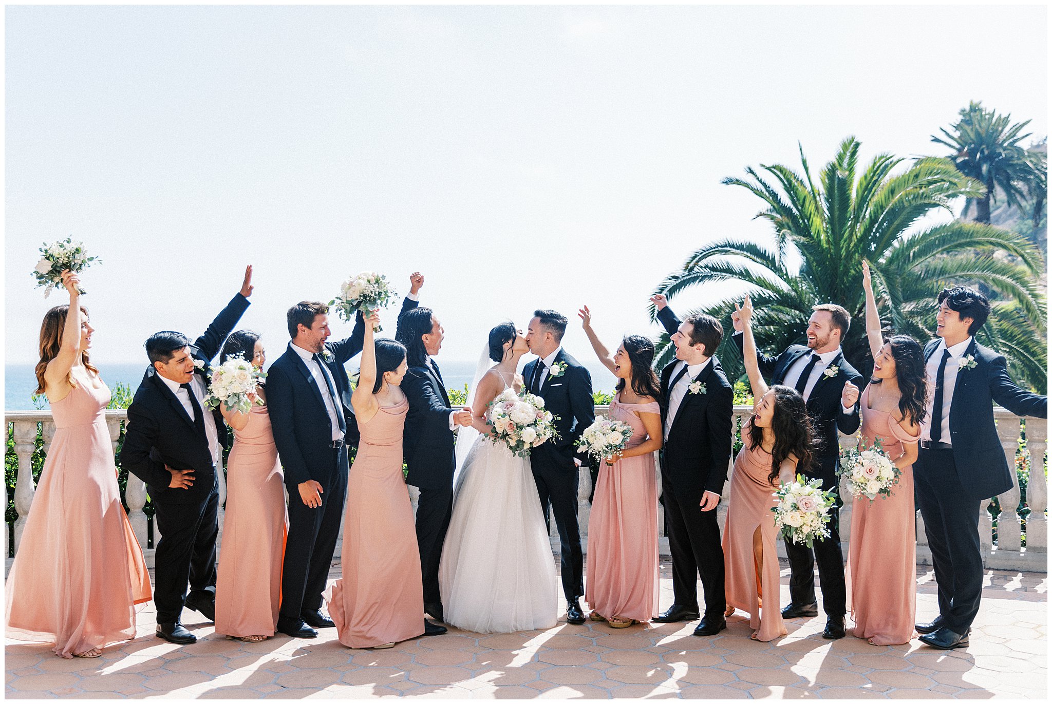 Wedding party celebrating on balcony of Bel Air Bay Club in Pacific Palisades, Ca.