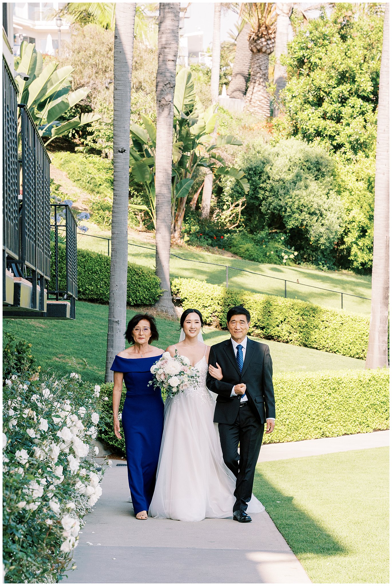 Both parents walking bride down the aisle at Bel Air Bay Club.