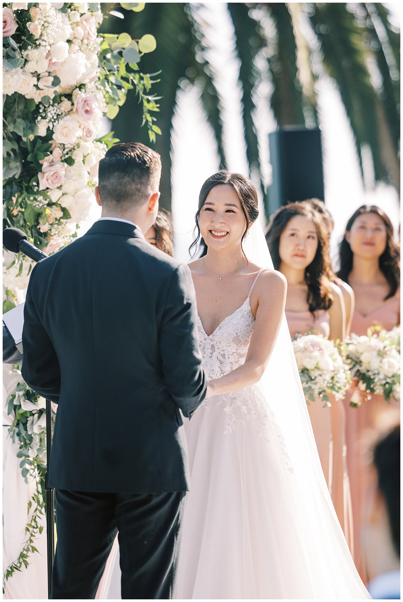 Bride smiling during vows at Bel Air Bay Club in Pacific Palisades, Ca by Teresa Marie Photography.