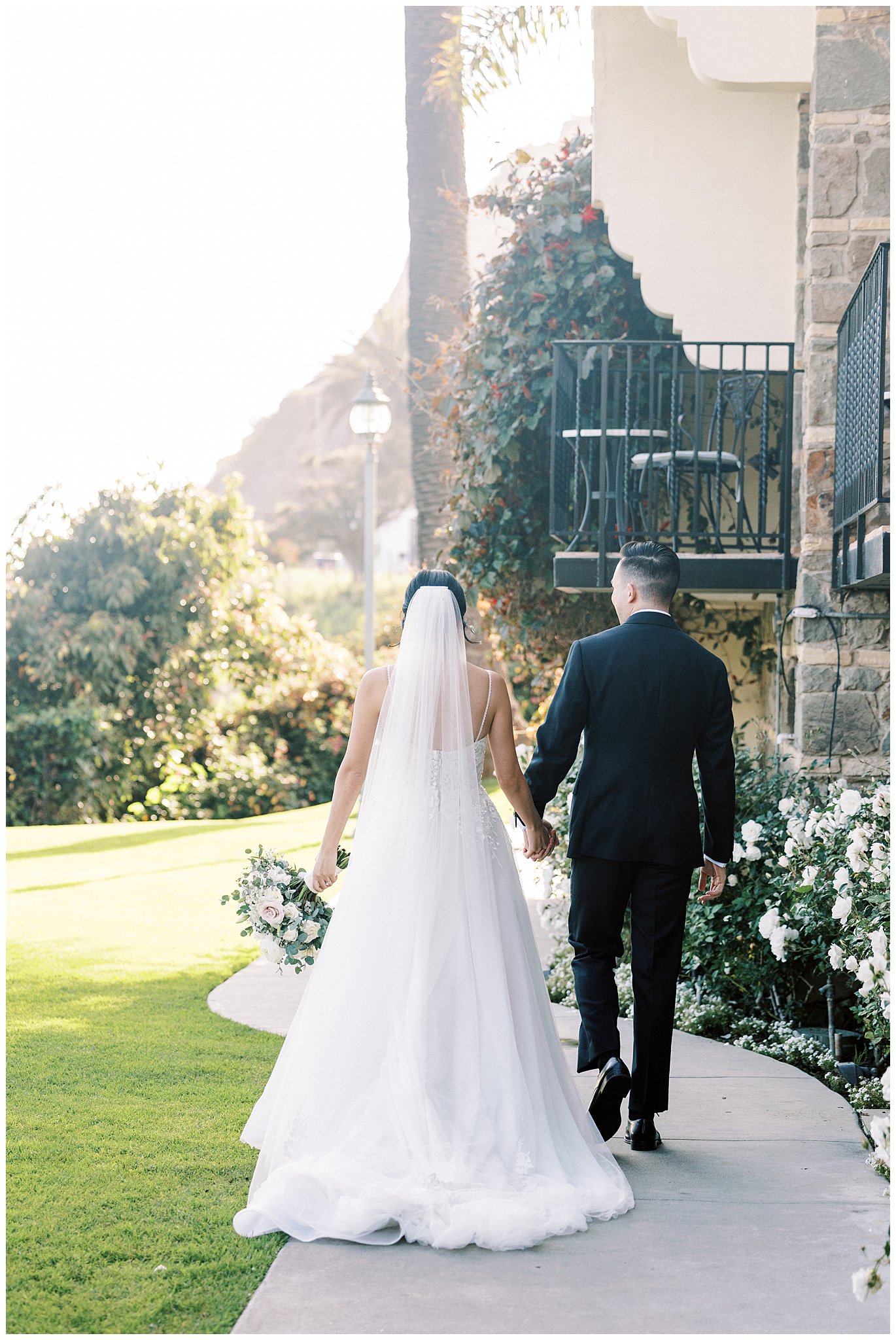 Bride and groom holding hands walking in Southern California.