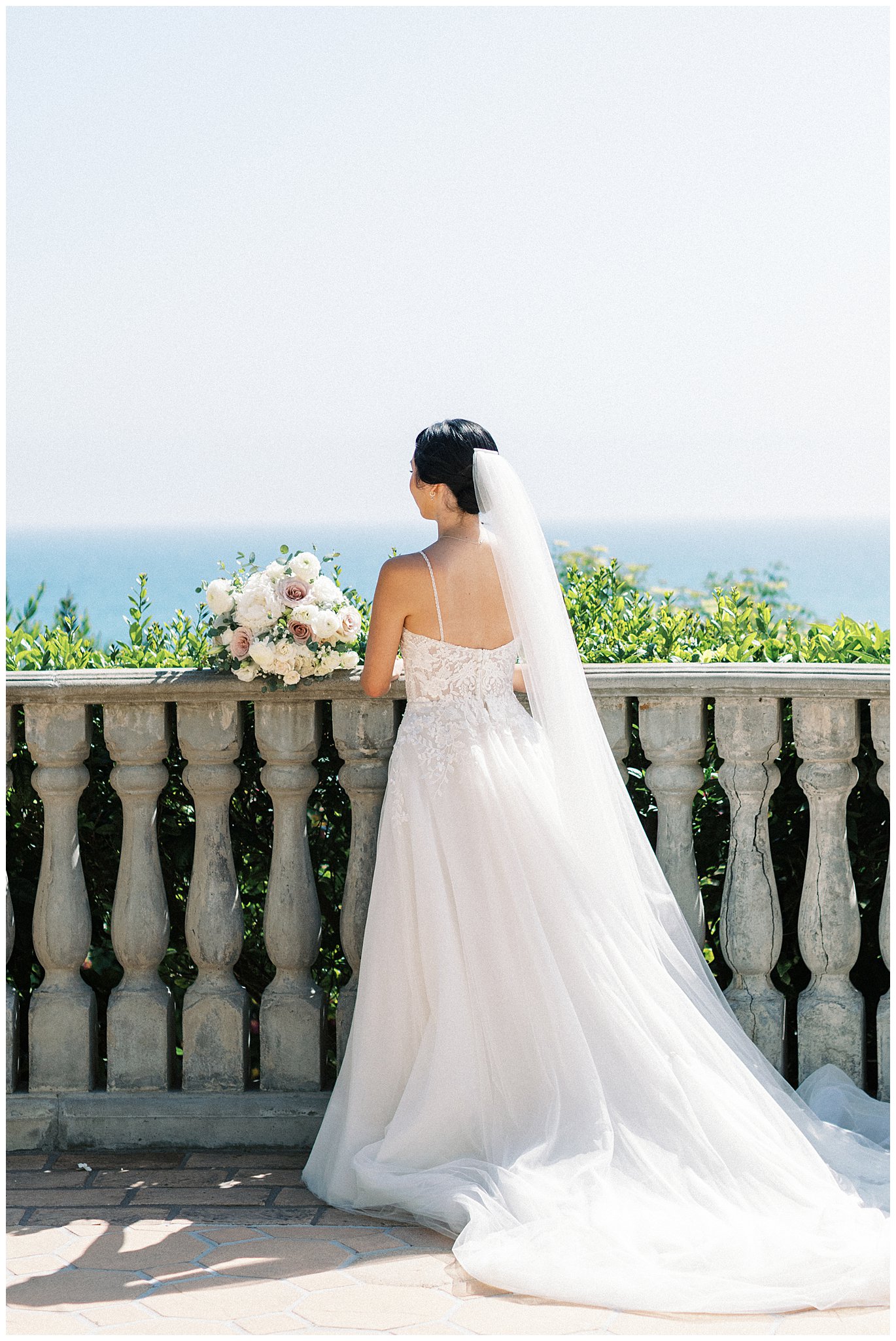 Bride looking at the ocean.