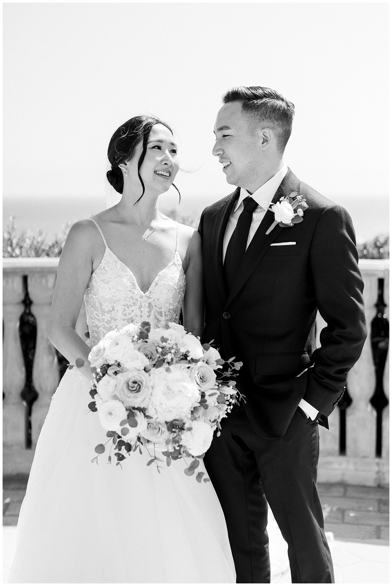 Bride and groom smiling at each other.  