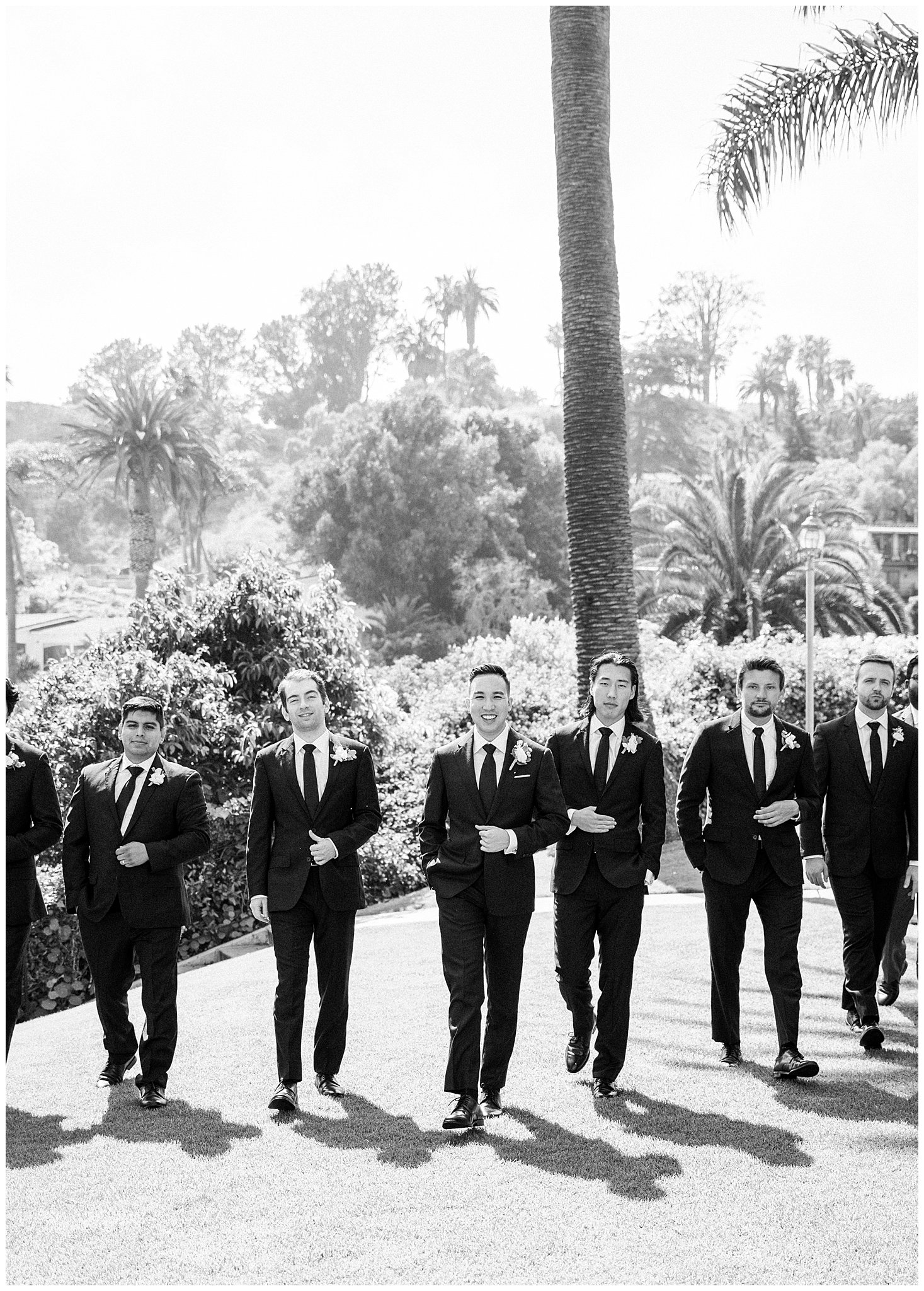 Groomsmen walking on lawn at Bel Air Bay Club in Pacific Palisades, Ca.