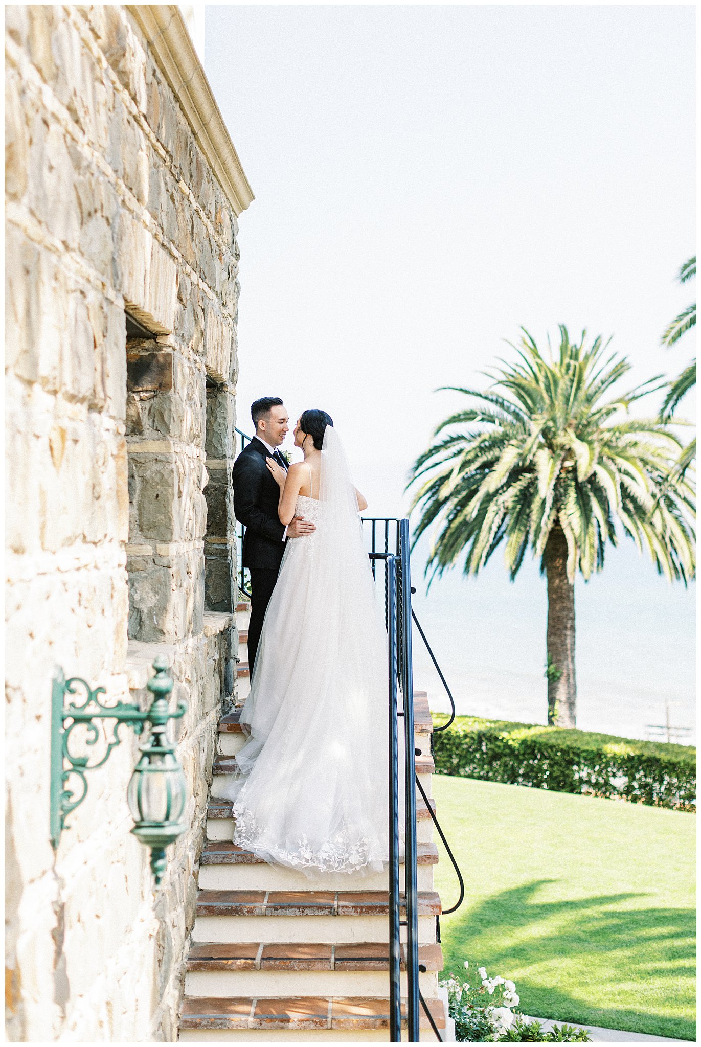 Bride and groom embracing on the stairs at Bel Air Bay Club.