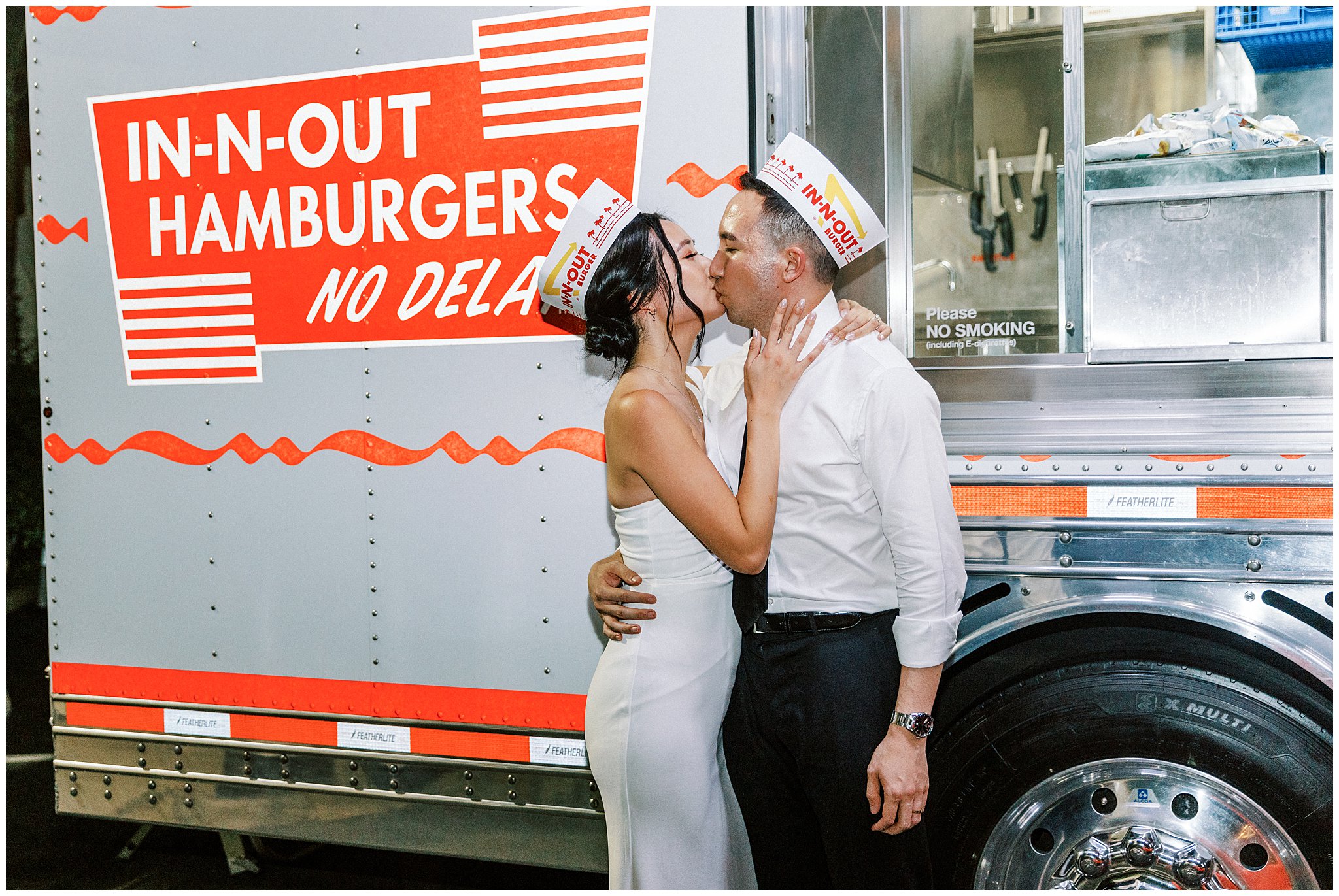 Bride and groom kissing in front of In-N-Out truck at Bel Air Bay Club.    