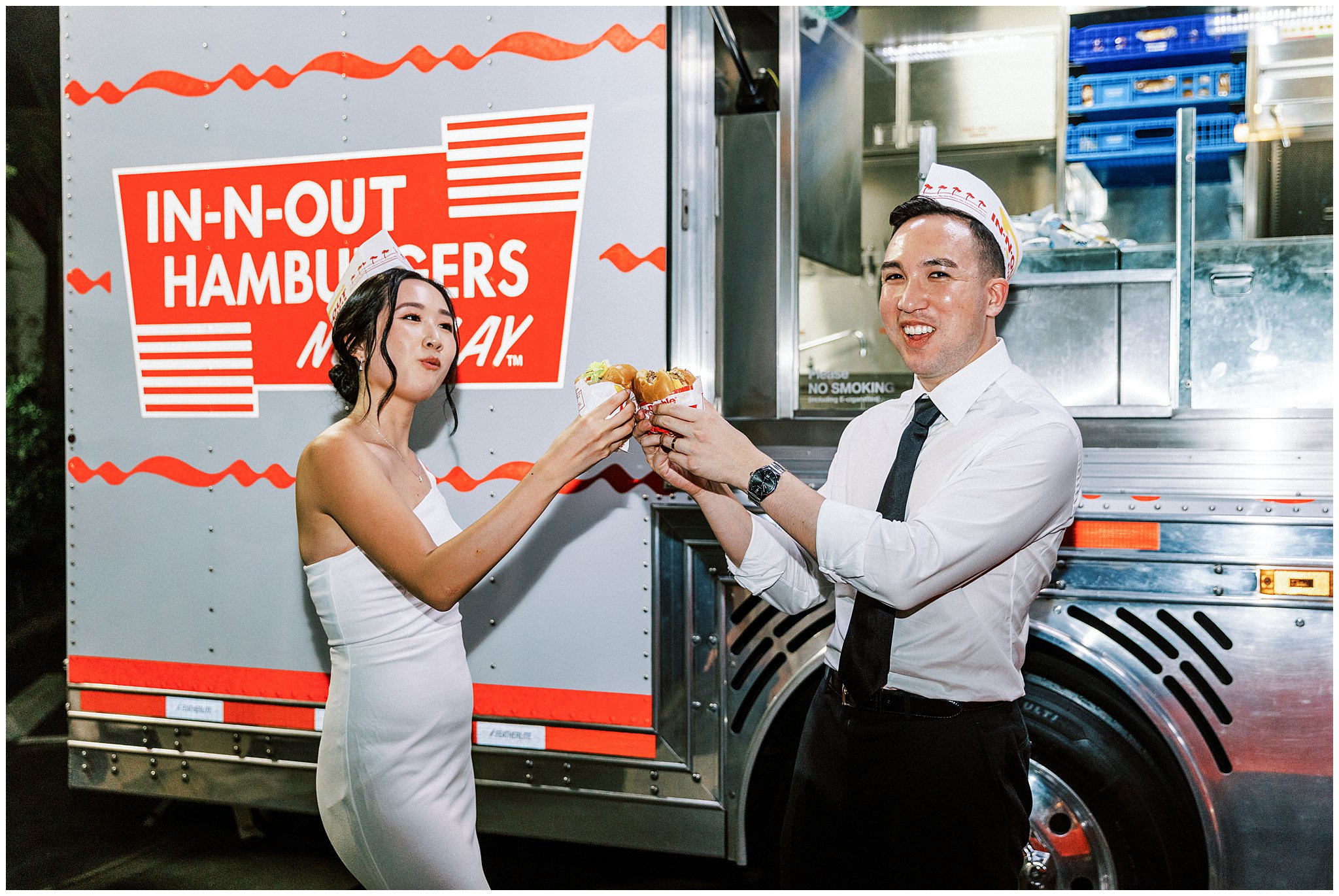 Bride and groom toasting a cheeseburger in front of In-N-Out truck at Bel Air Bay Club.  