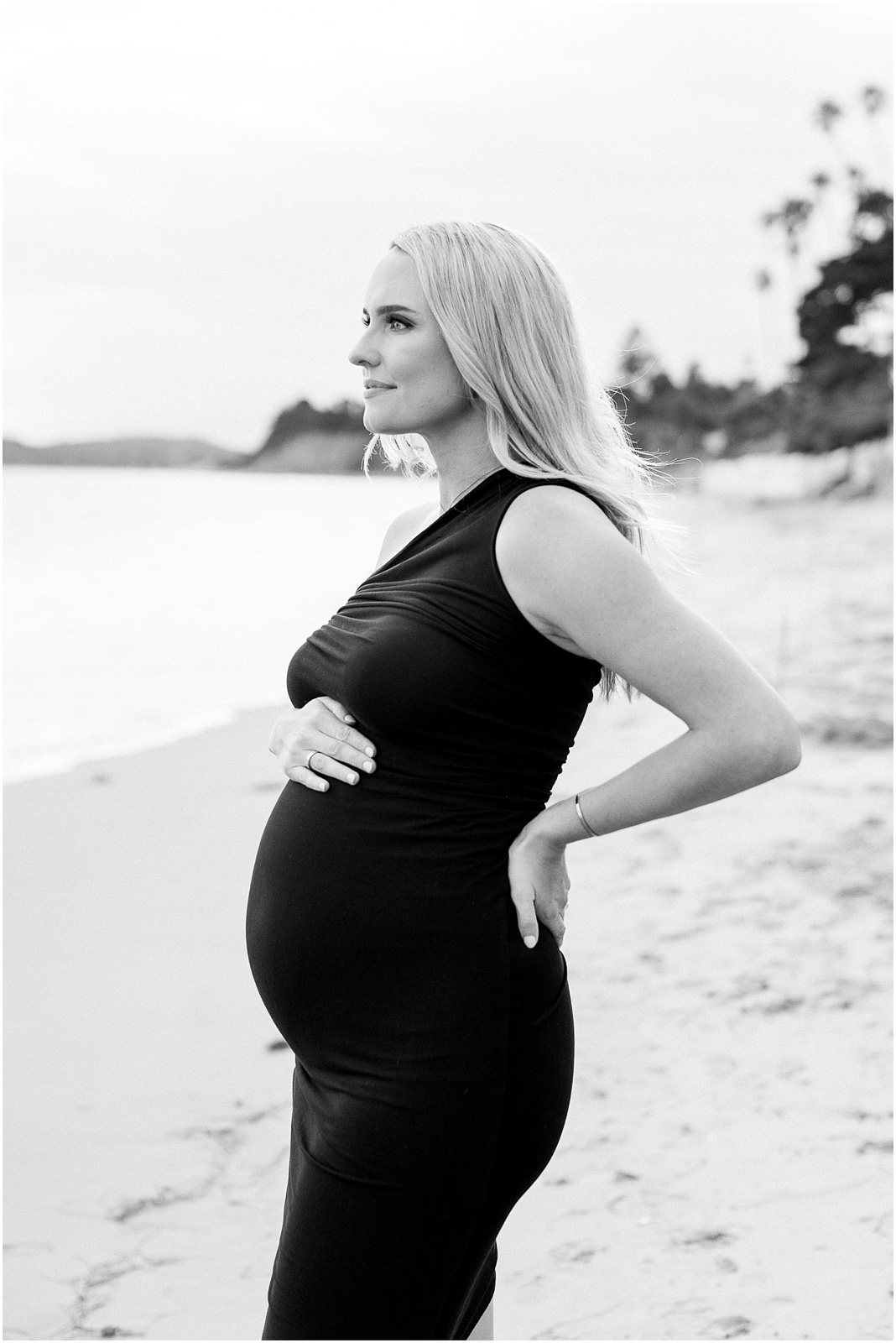 A pregnant mom standing on the beach in Montecito, Ca.