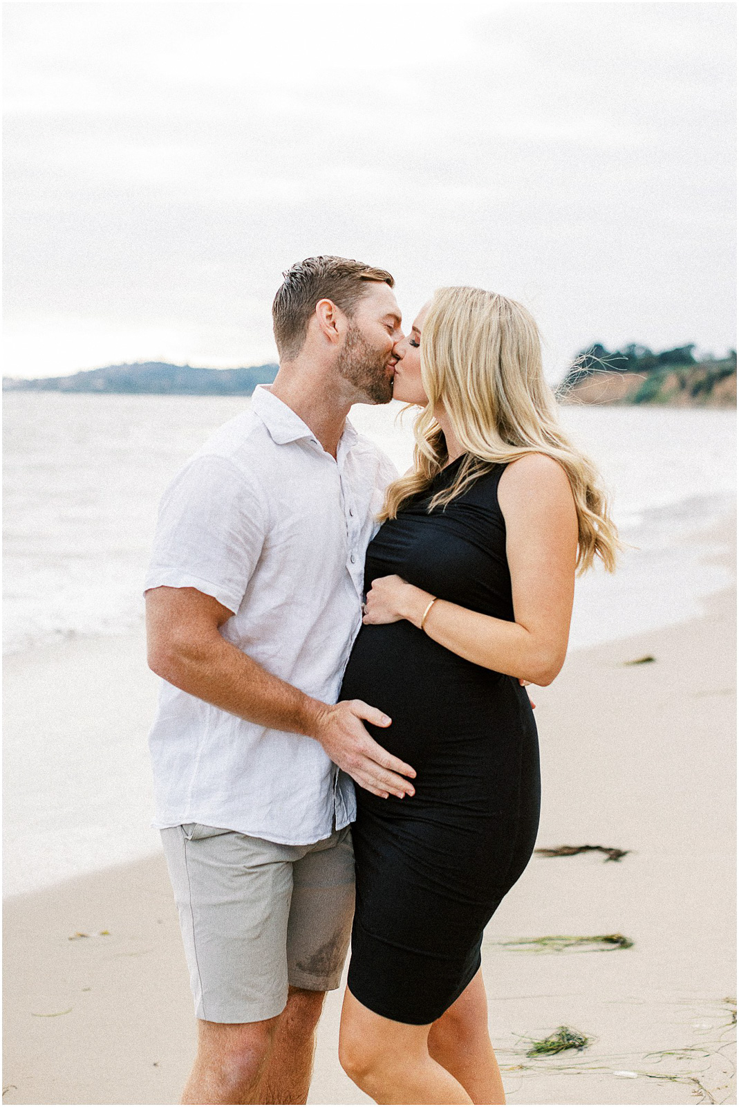 A married couple kissing in the water in Montecito, Ca.