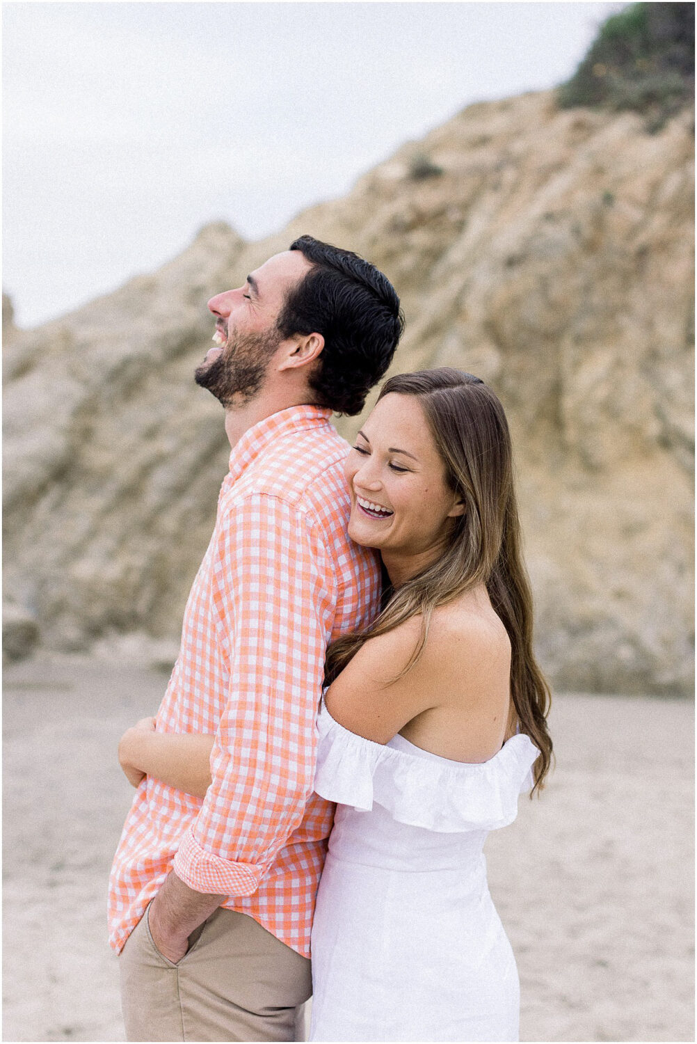 A couple laughing during a photo session in Malibu, Ca.