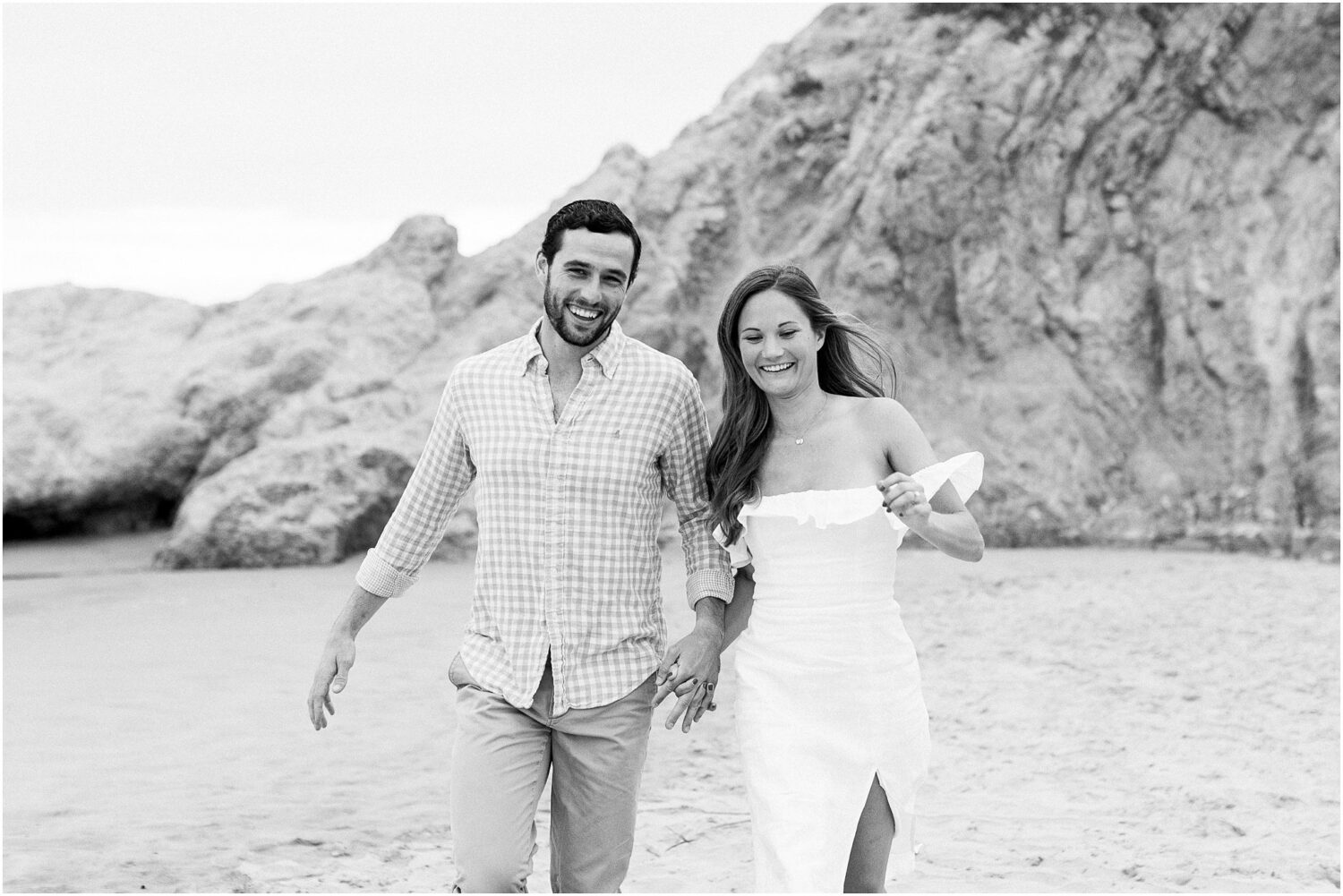 A couple running on the beach in Malibu, Ca.