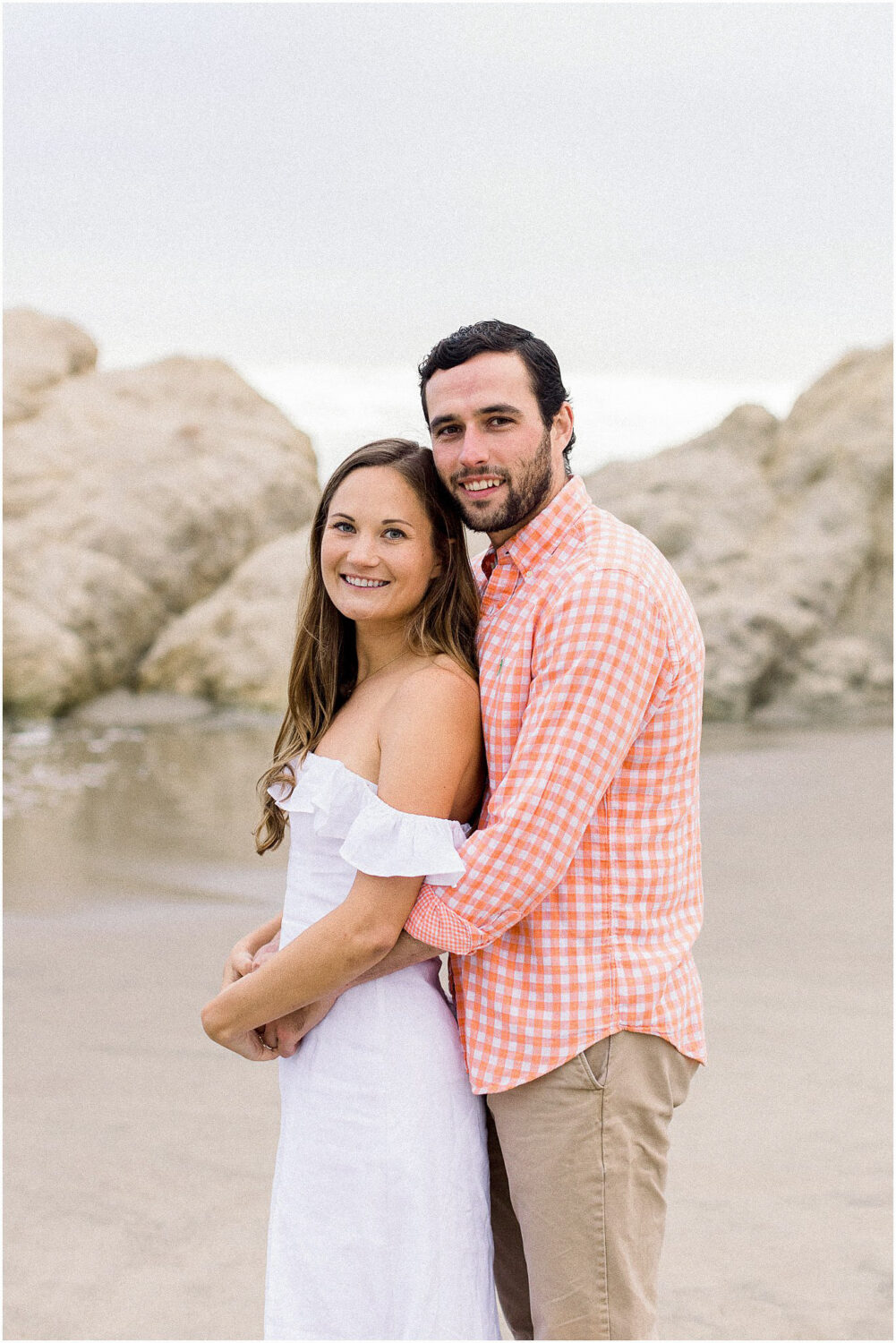 An engaged couple posing for a portrait at Leo Carrillo in Malibu, Ca.