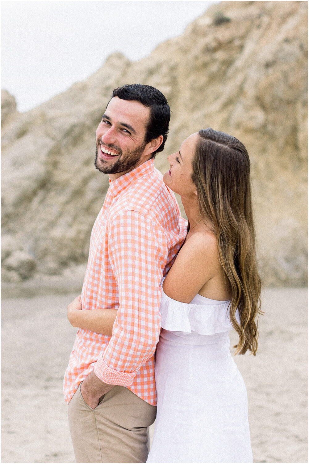 A couple being silly at the beach in Malibu, Ca.