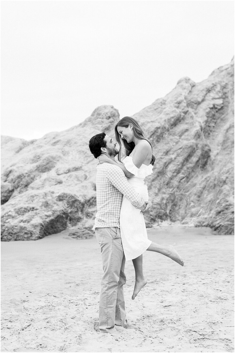 A couple having fun on the sand at Leo Carrillo beach in Malibu, Ca.