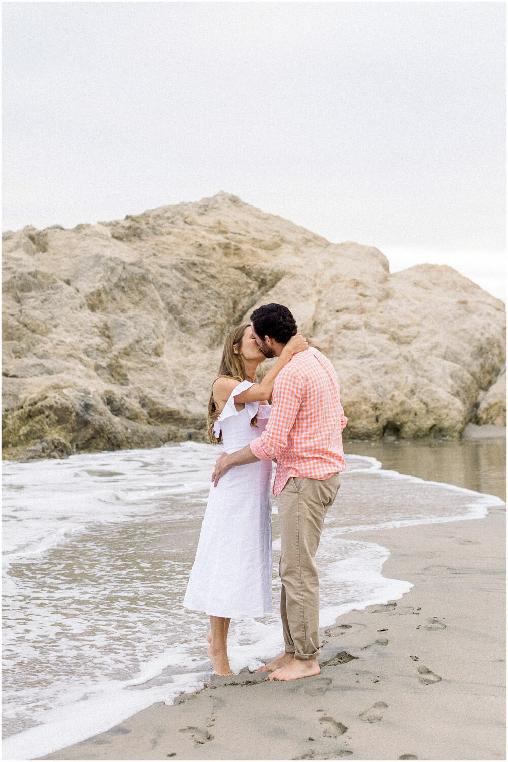 A couple kissing on the coast in Malibu, Ca.