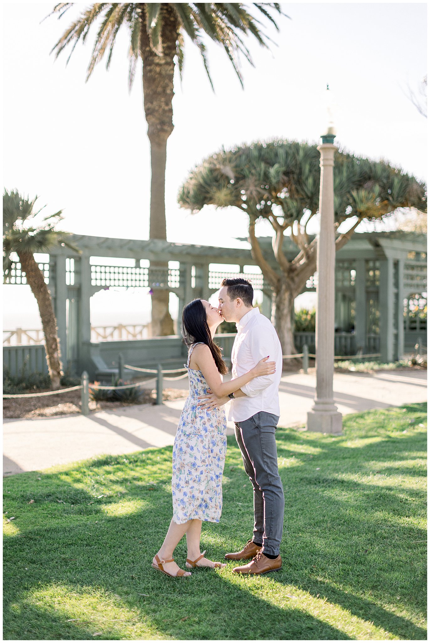 A couple sharing a kiss during a photo session at Palisades Park in Santa Monica.