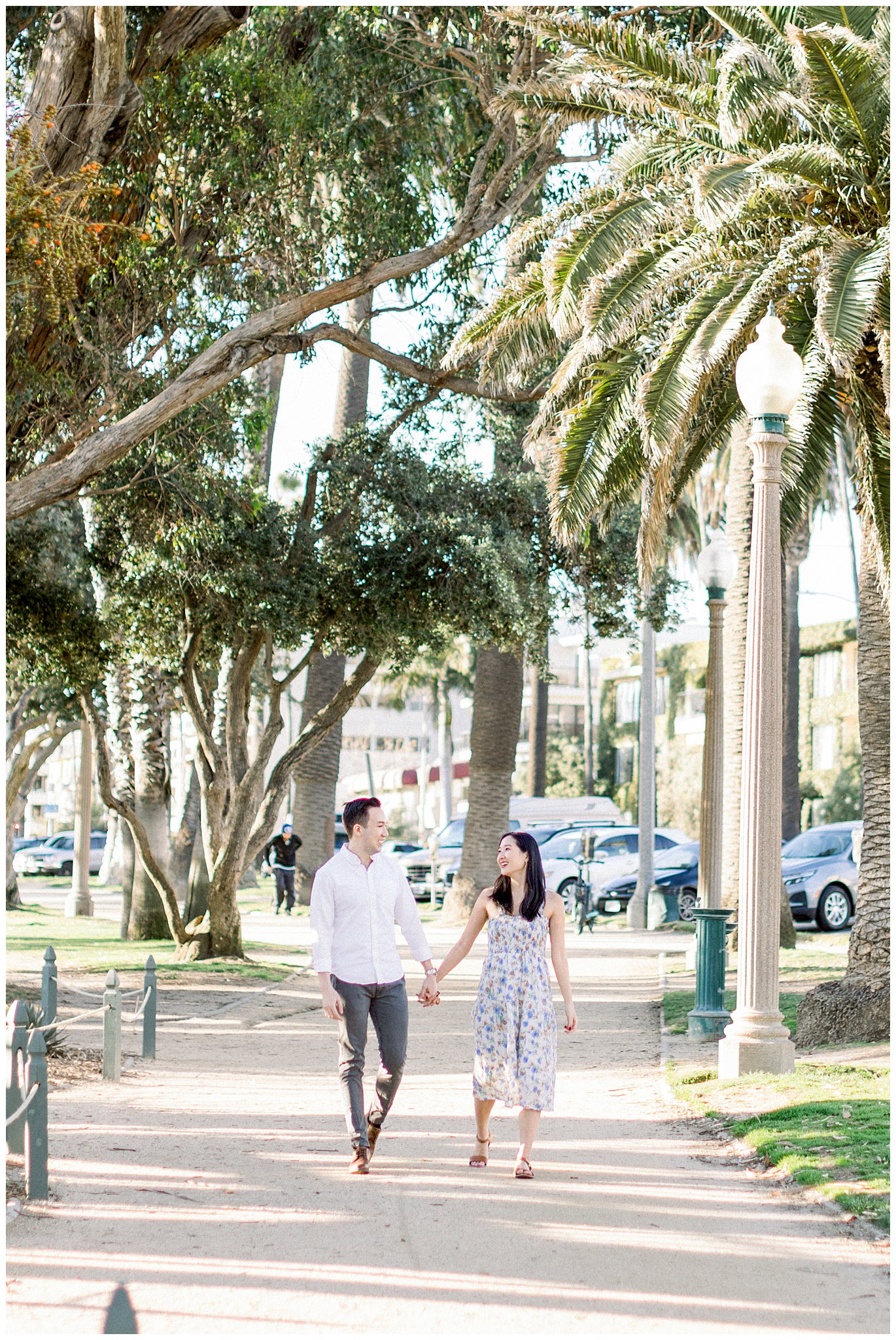 A couple walking hand in hand during a photo session at Palisades Park.