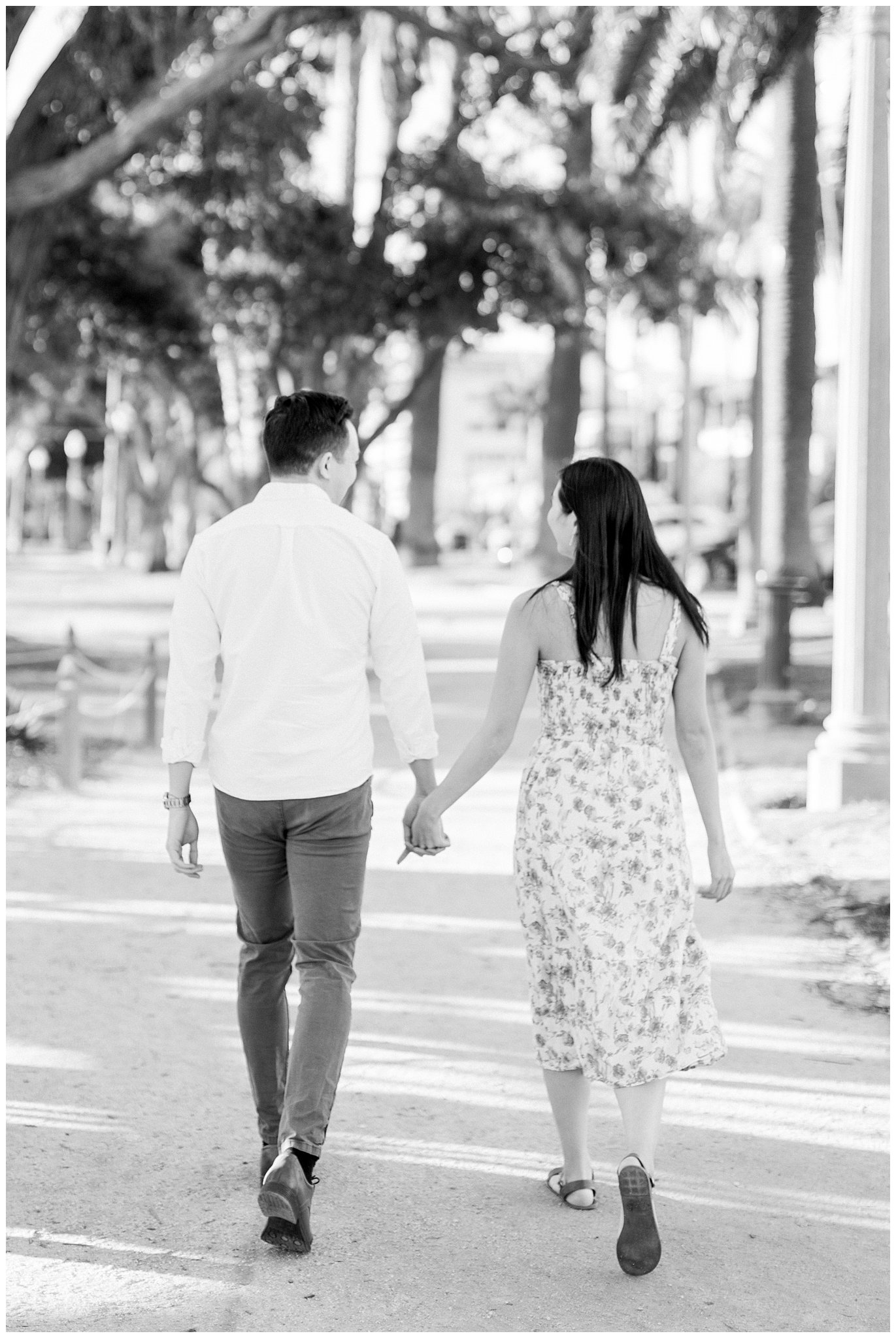 An engaged couple walking together during a photo session at Palisades Park.