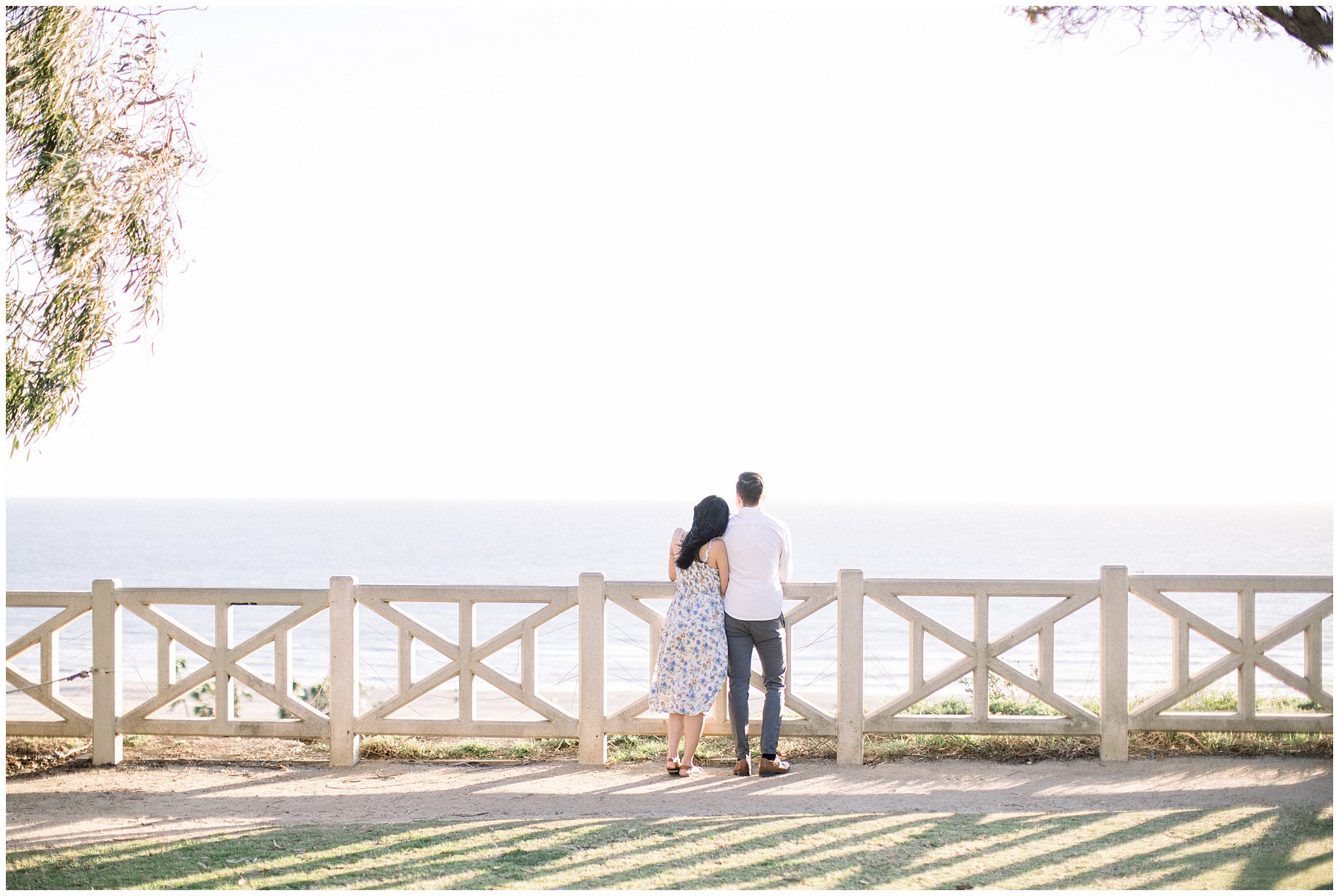 A couple enjoying the panoramic ocean view from Palisades Park during an engagement session.