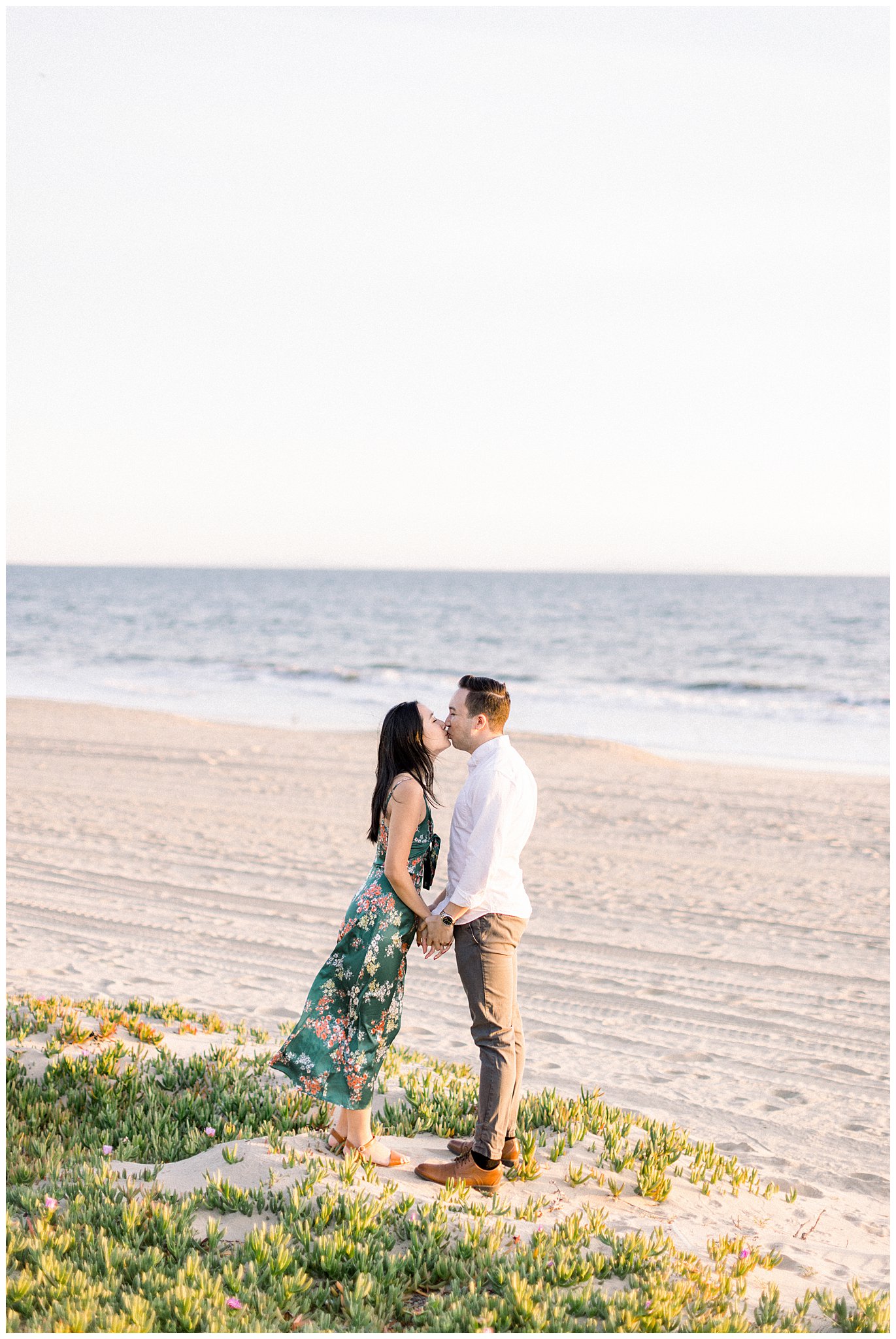 A couple enjoying a kiss during an engagement session at the beach in the Pacific Palisades.