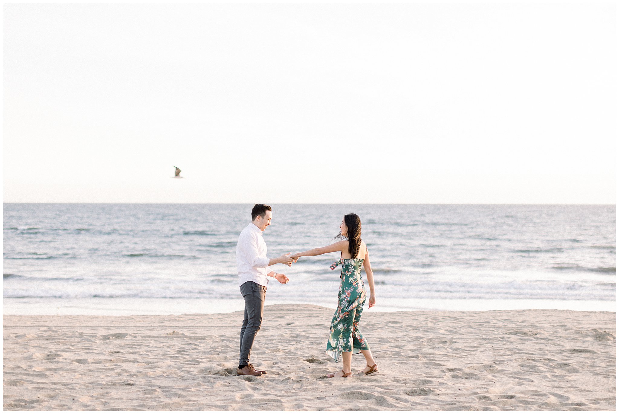 A couple being silly during their engagement session at Will Rogers Beach.  