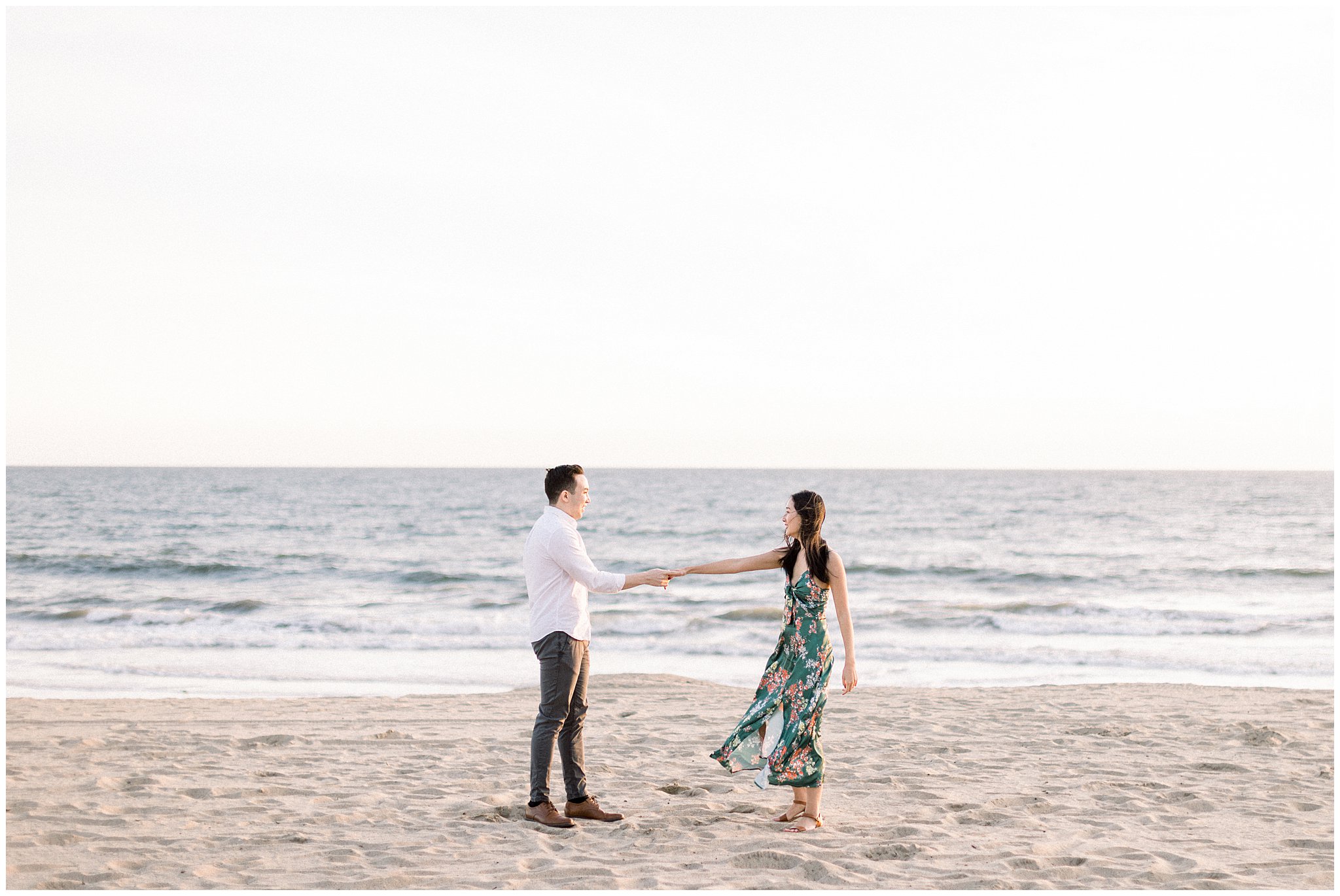 A engaged couple having fun during their engagement session at Will Rogers beach.