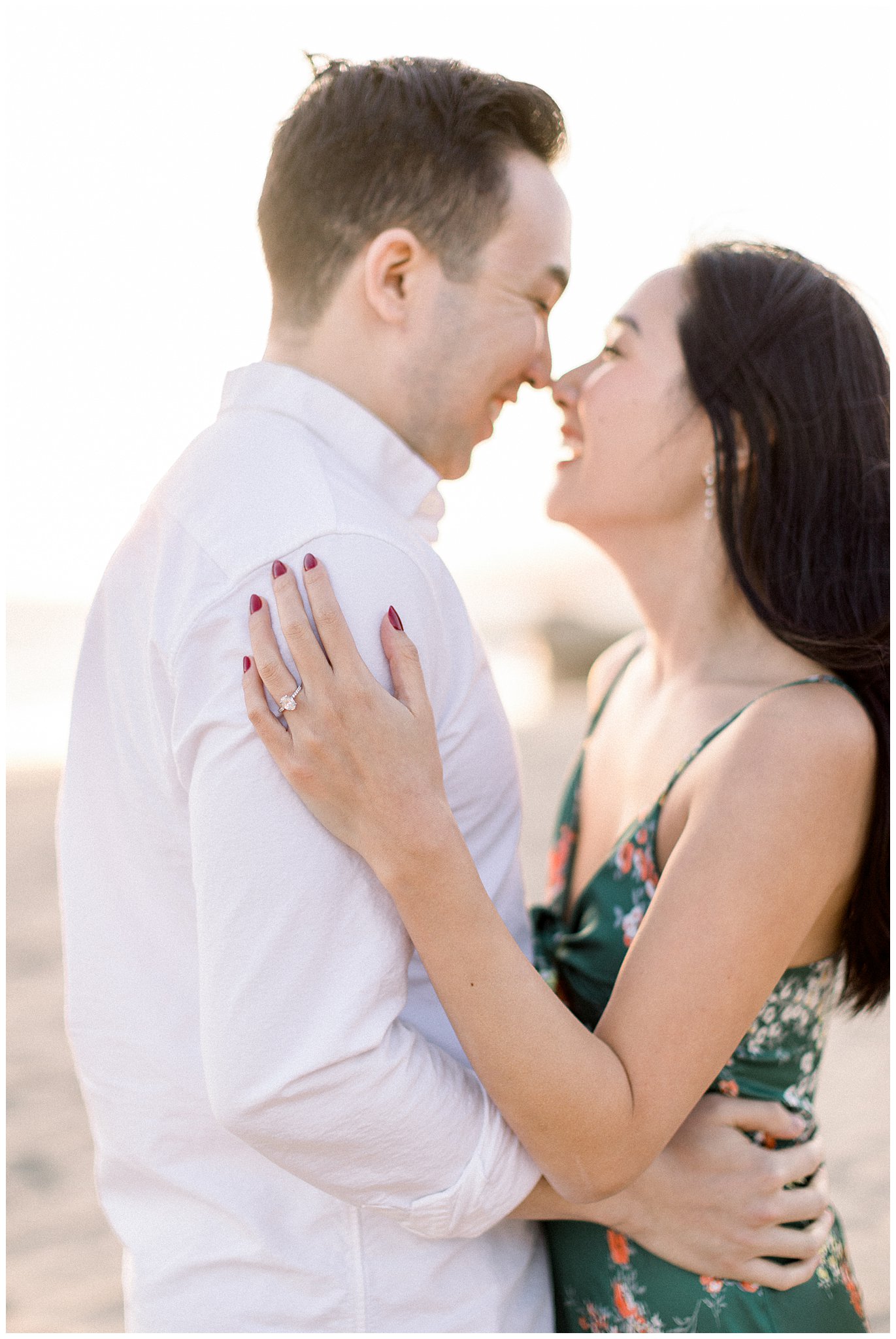 A blissful couple and an engagement ring at the beach in Santa Monica, Ca.