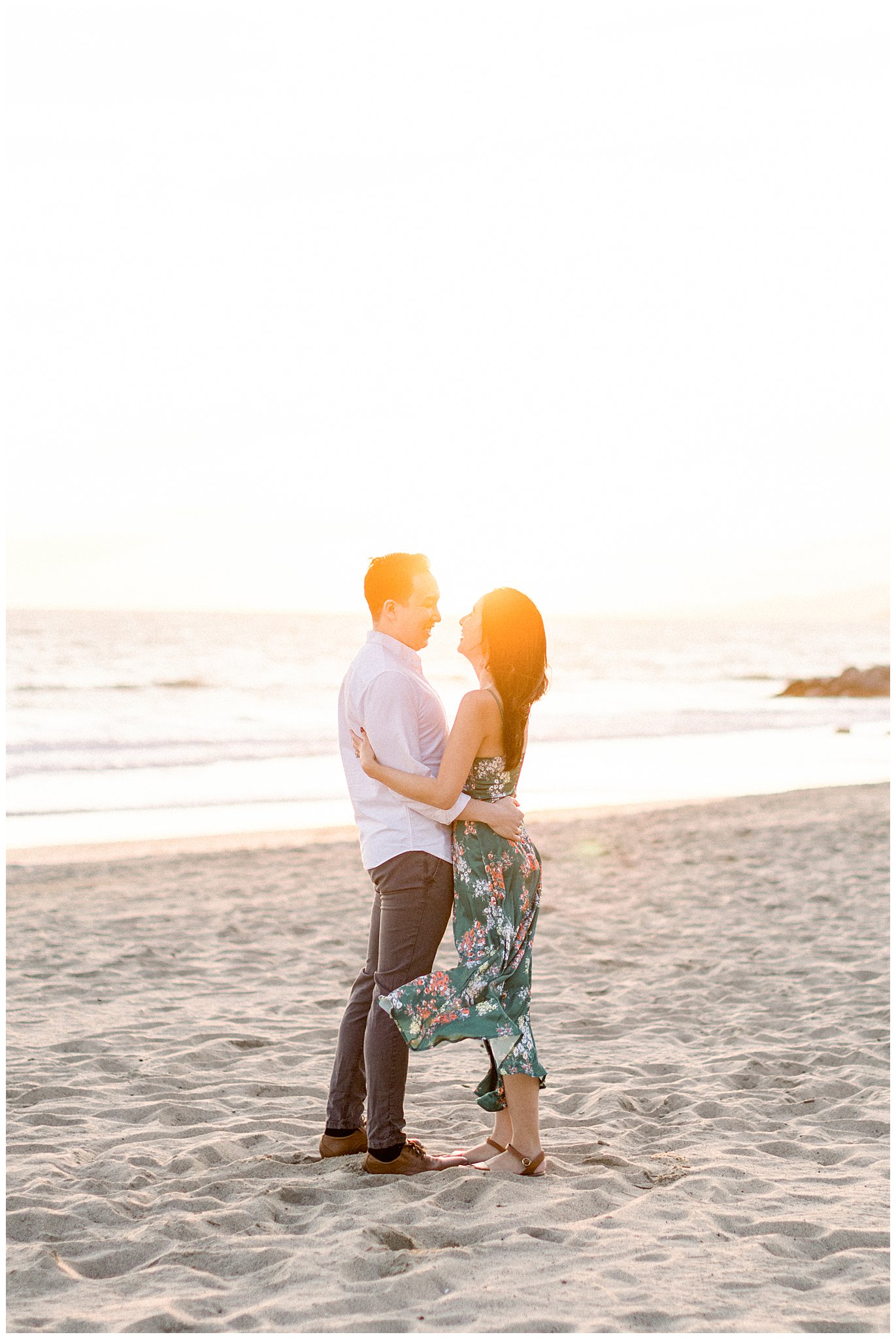 A couple enjoying a moment together during their engagement session at Palisades beach.