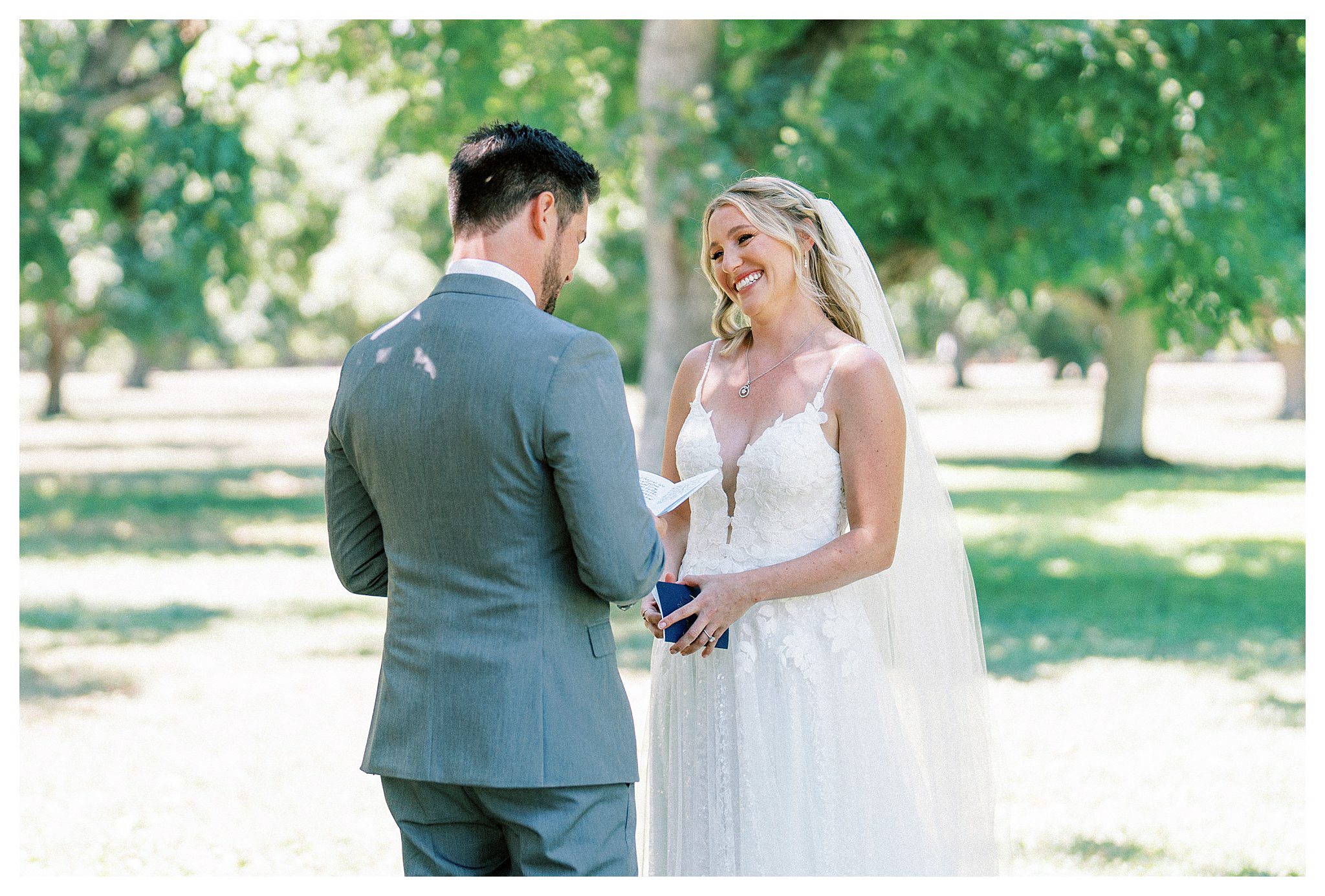 Bride smiling while the groom recites his vows in Moorpark, Ca.