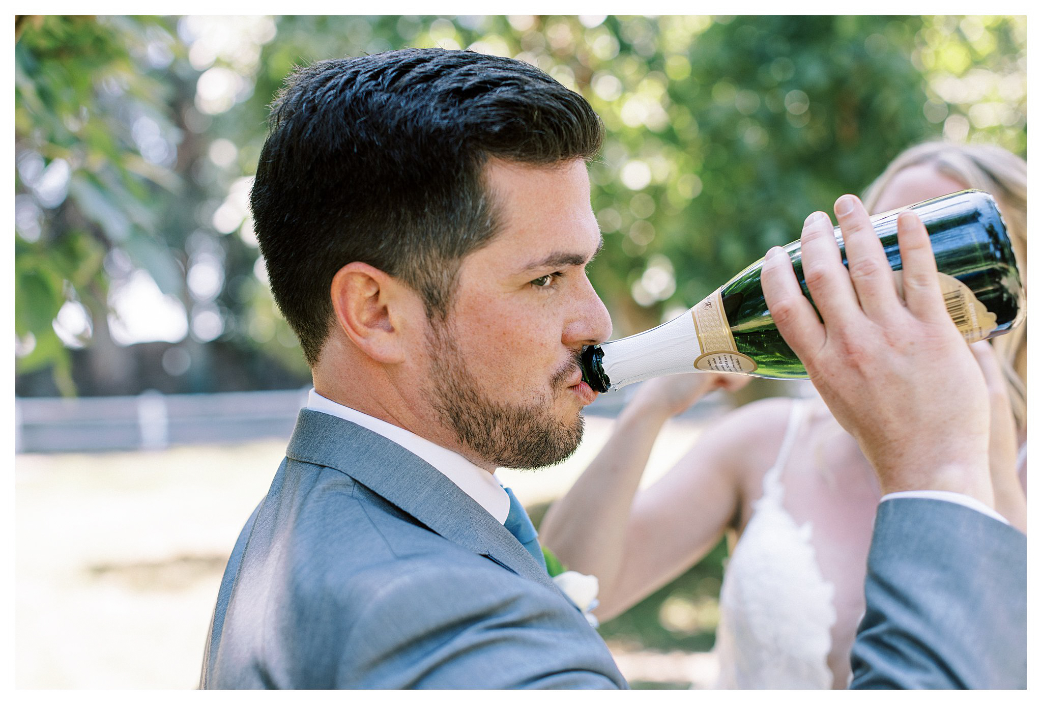 Groom drinking from a bottle of champagne in Moorpark, Ca. 