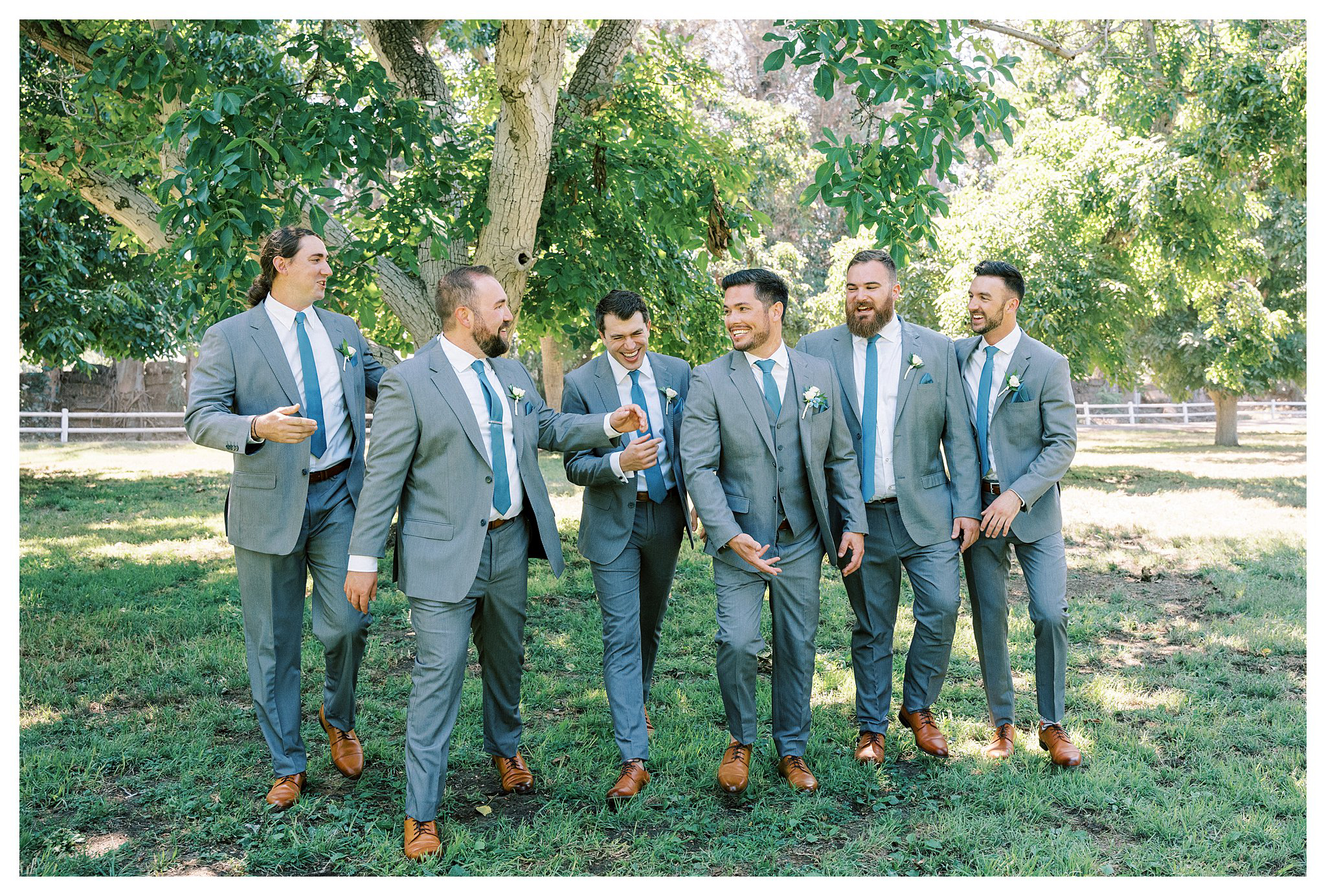 The groom and his groomsmen walking at Walnut Grove.  