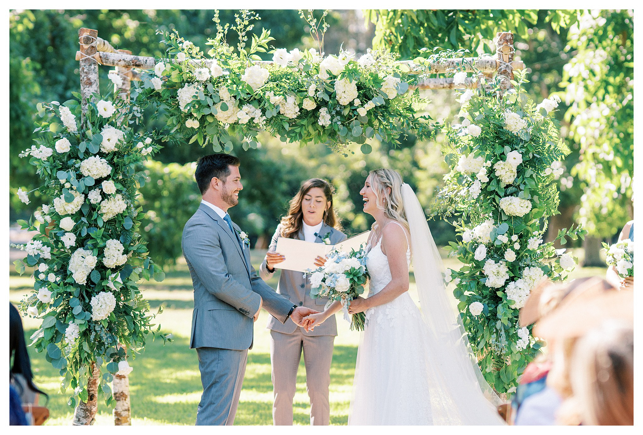 Bride and groom smiling at each other during the ceremony at Walnut Grove in Moorpark, Ca.