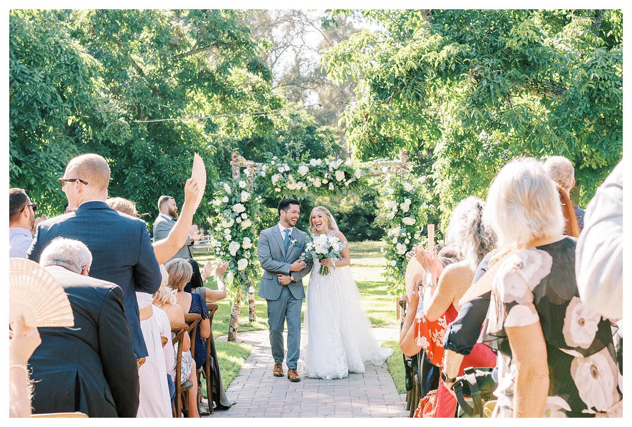 The newlyweds processional full of smiles in Moorpark, Ca.