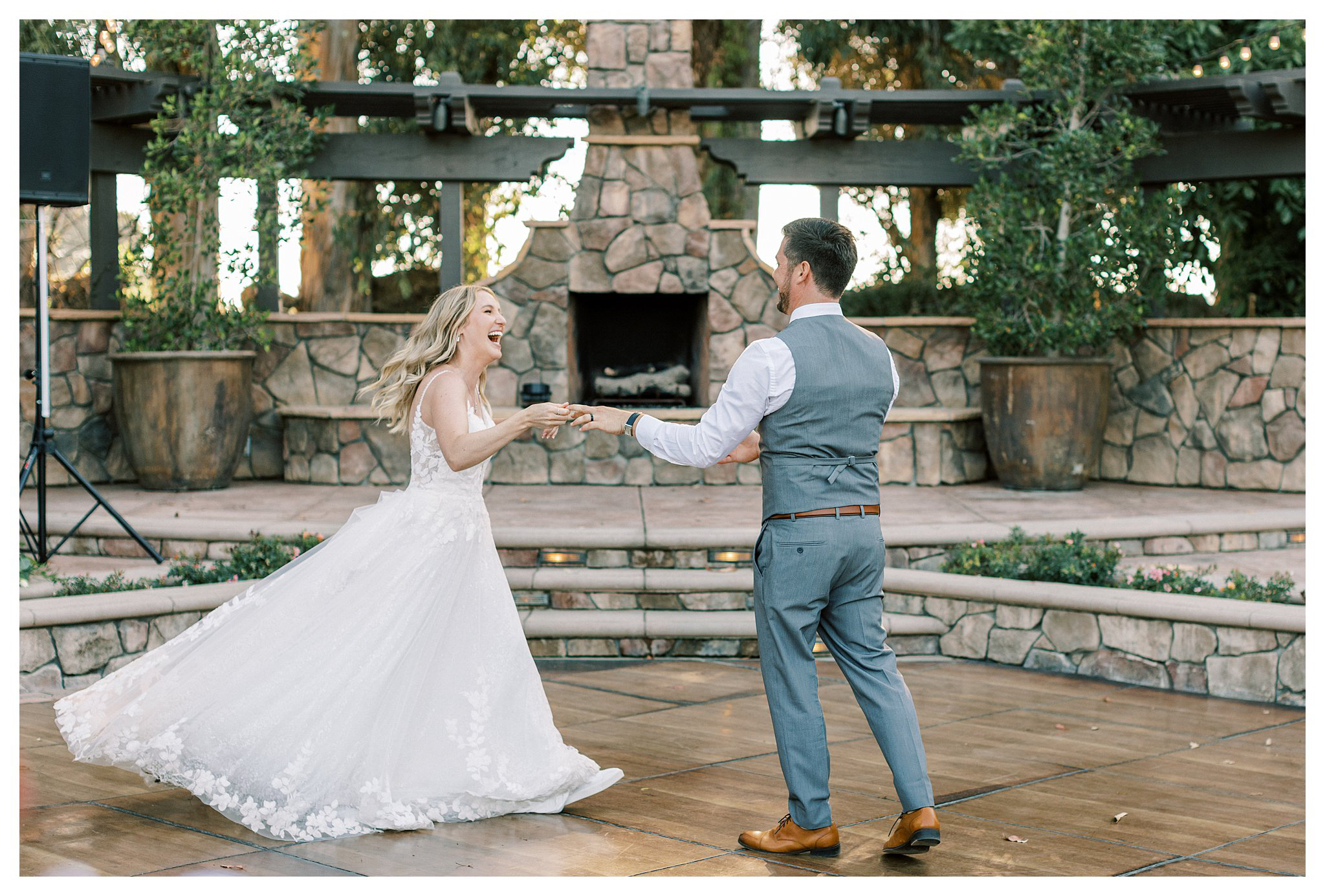 The bride and groom's smiling during the first dance at a Walnut Grove wedding.