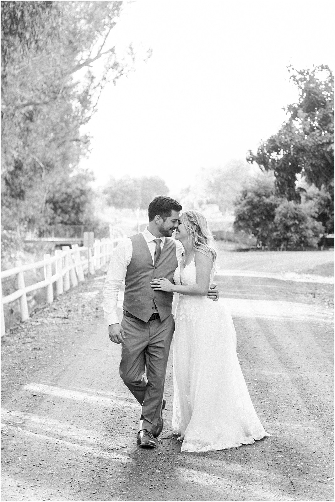 Bride and groom walk along a path during sunset photos at Walnut Grove.