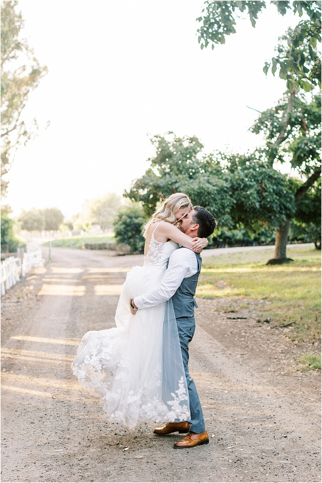 The groom picking up his bride during golden hour at Walnut Grove.