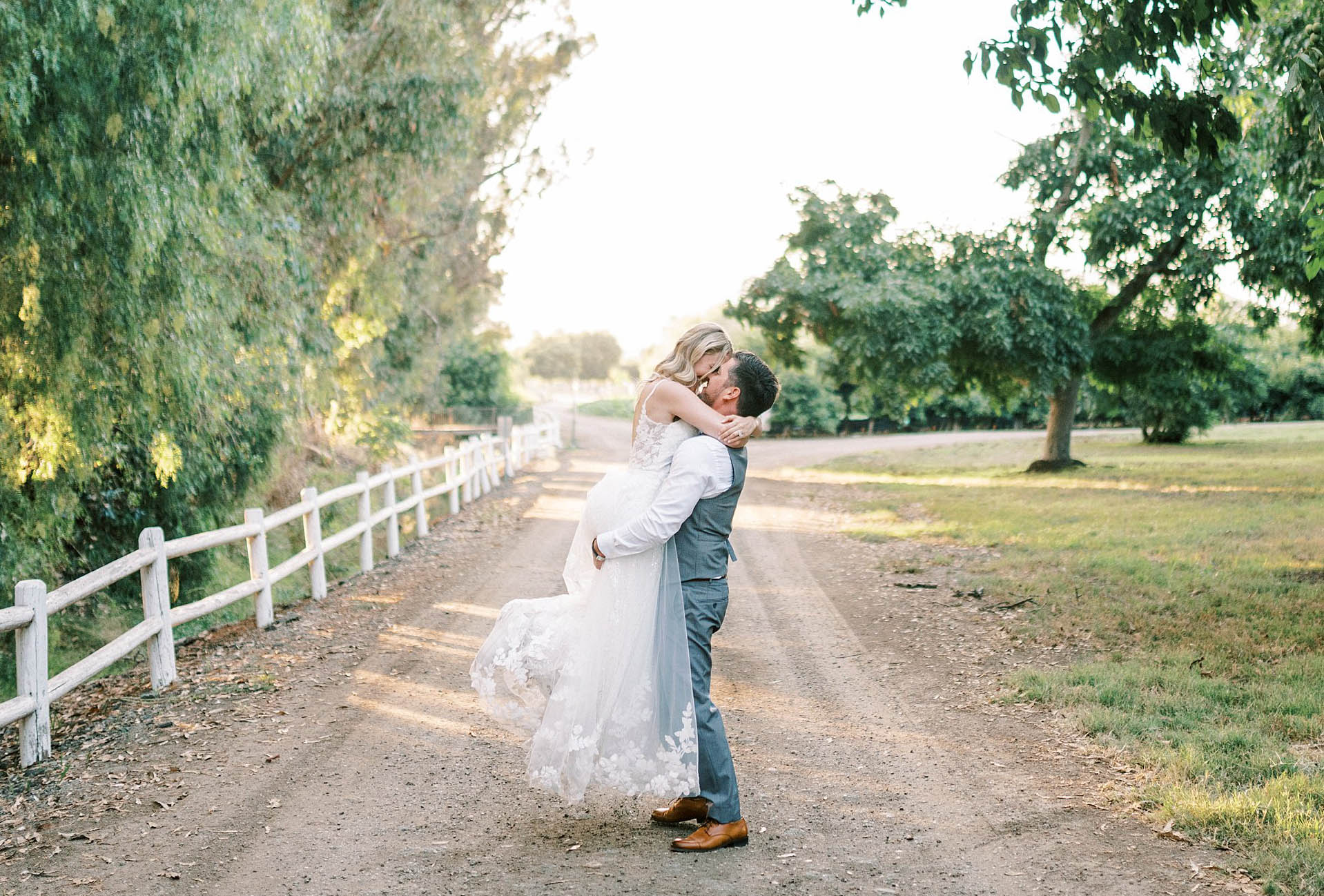 Newlyweds kissing on a path during golden hour at Walnut Grove in Moorpark, Ca.