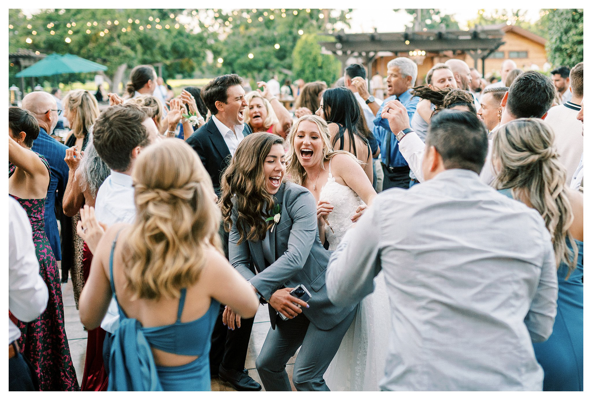 The bride dancing with friends during the reception at Walnut Grove wedding.